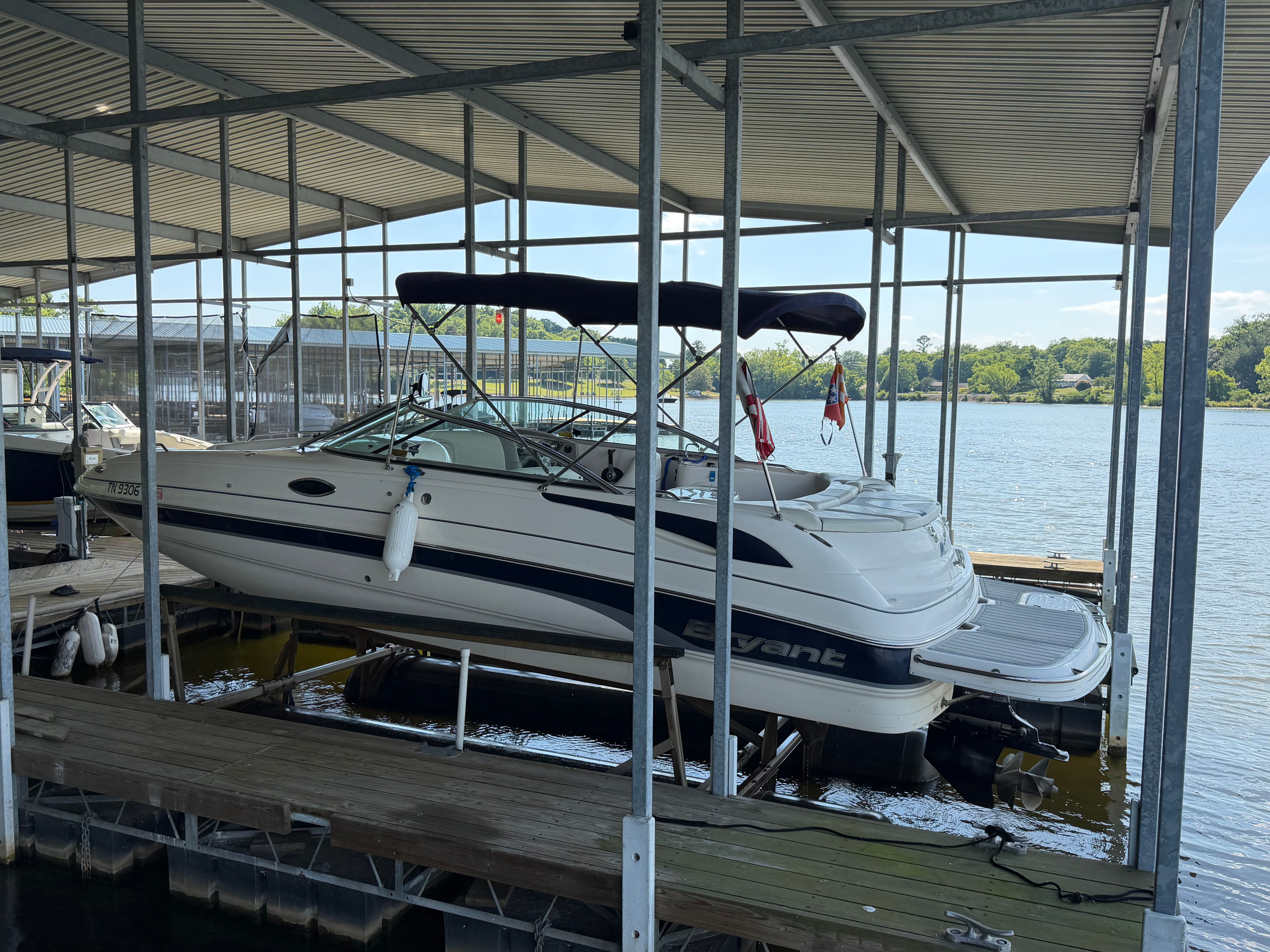 2010 Bryant 255 boat docked under a covered marina.