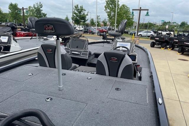 2025 Ranger ALPHA 208 boat with spacious deck and modern seating, displayed outdoors.