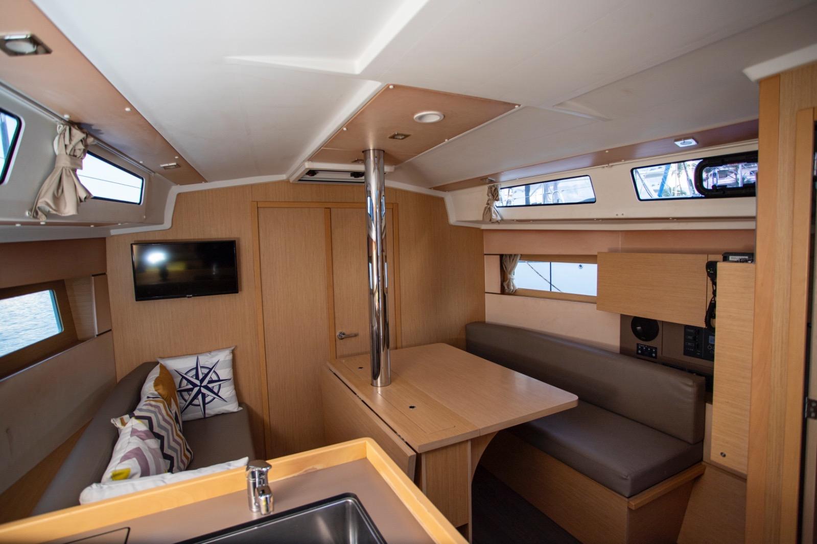 Interior of 2019 Beneteau Oceanis 38.1 yacht, featuring cozy seating and modern design.