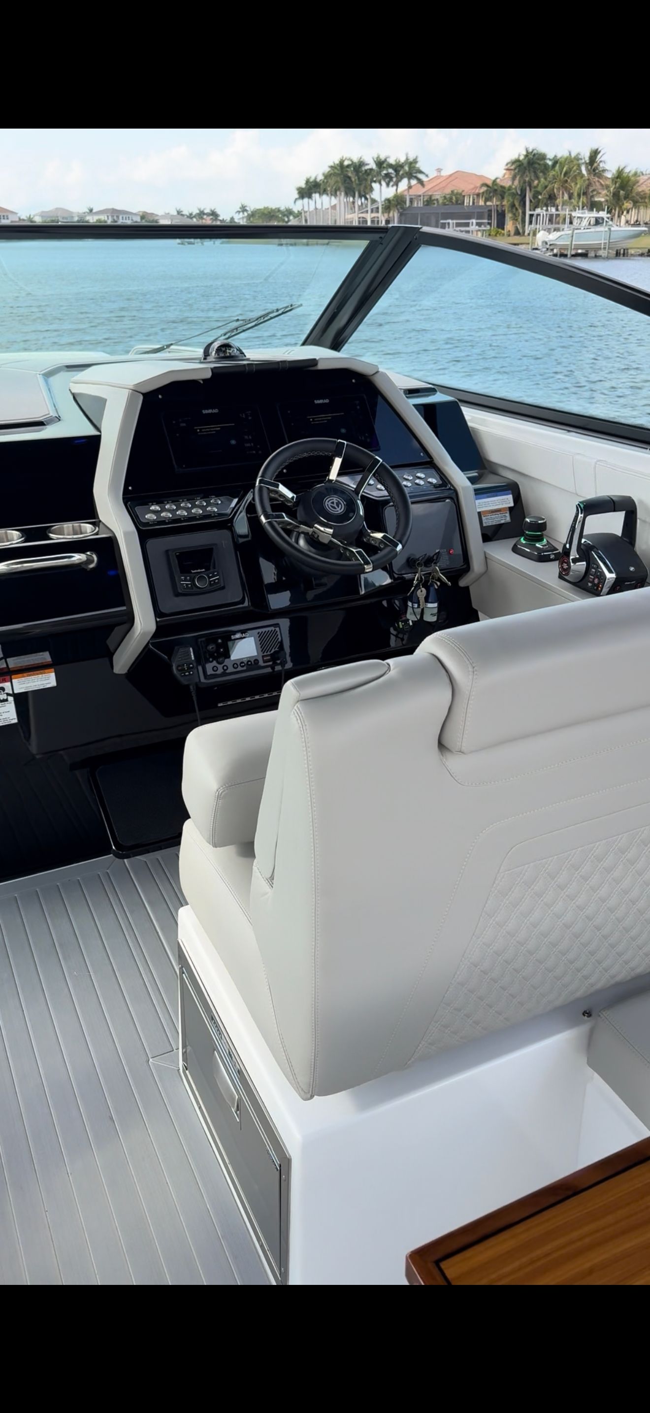 The cockpit of a modern yacht with a sleek helm and comfortable seating.