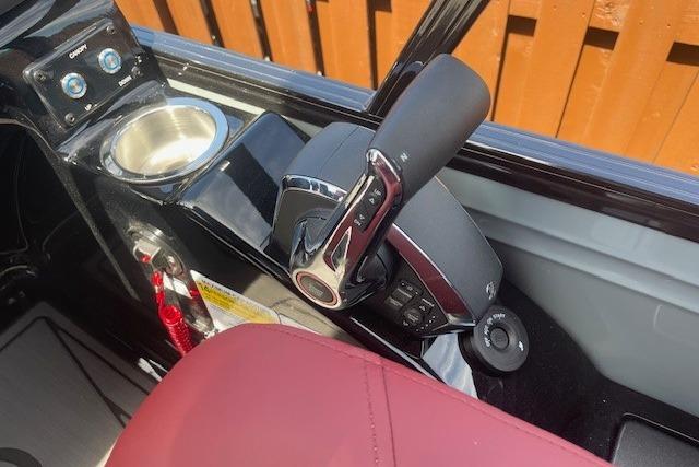 Control panel of 2026 Regency 250 DL boat with throttle and cup holder.