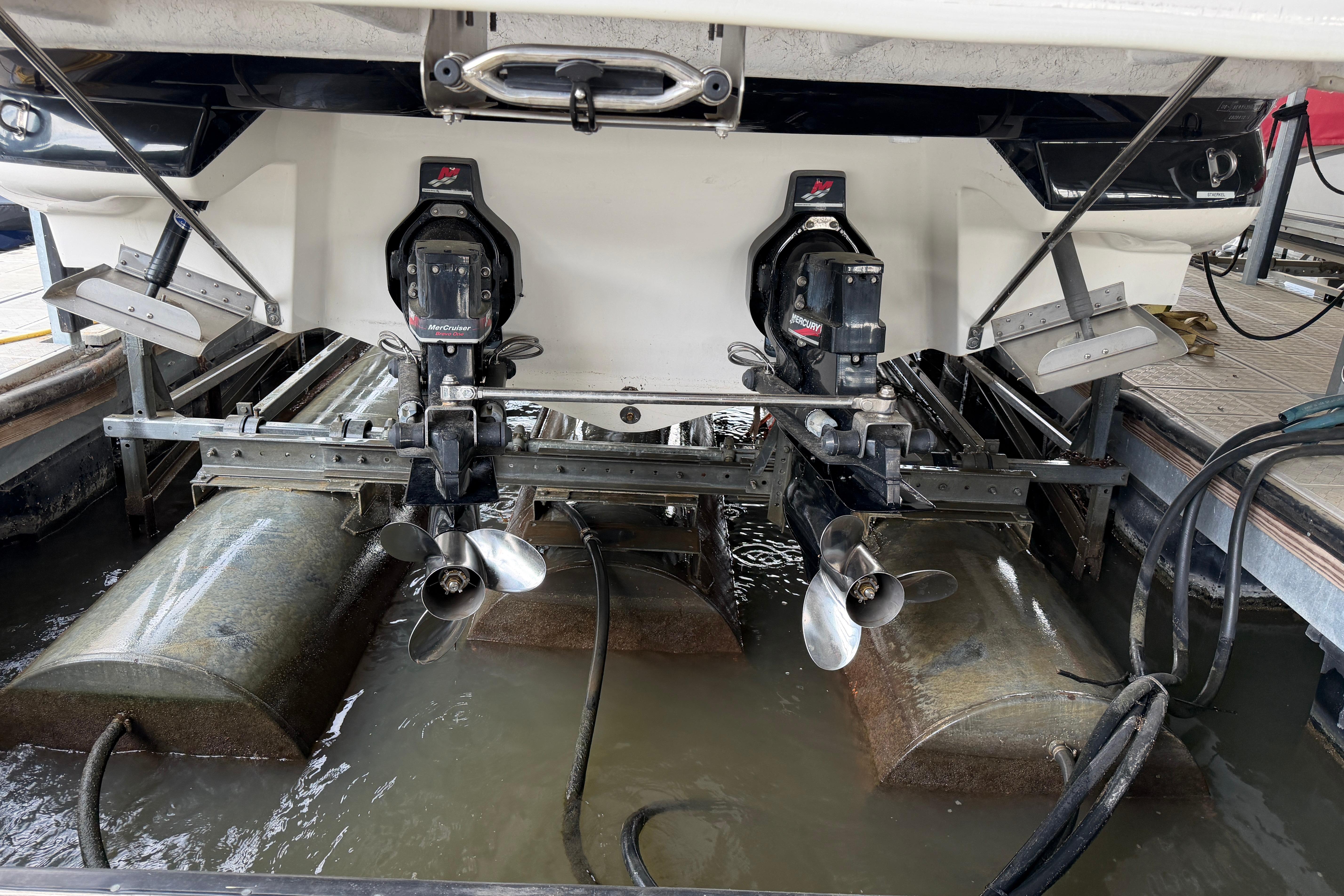 2003 Sea Ray 290 Bowrider with dual propellers in a marina setting.