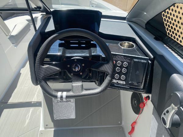 2025 Scarab 235 SE boat dashboard with steering wheel and control panel.