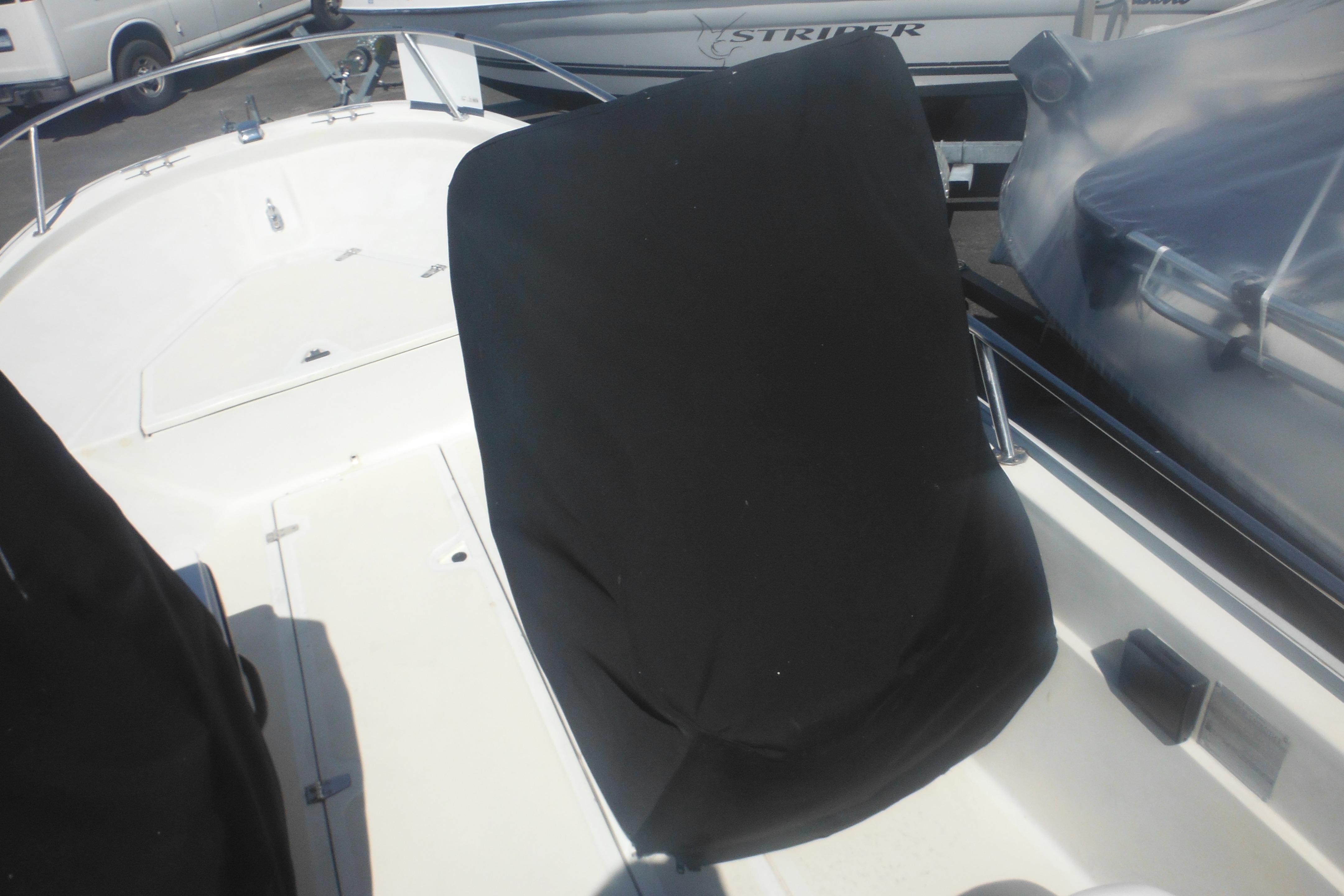 1991 Boston Whaler 16 SL boat interior with covered seating and deck view.