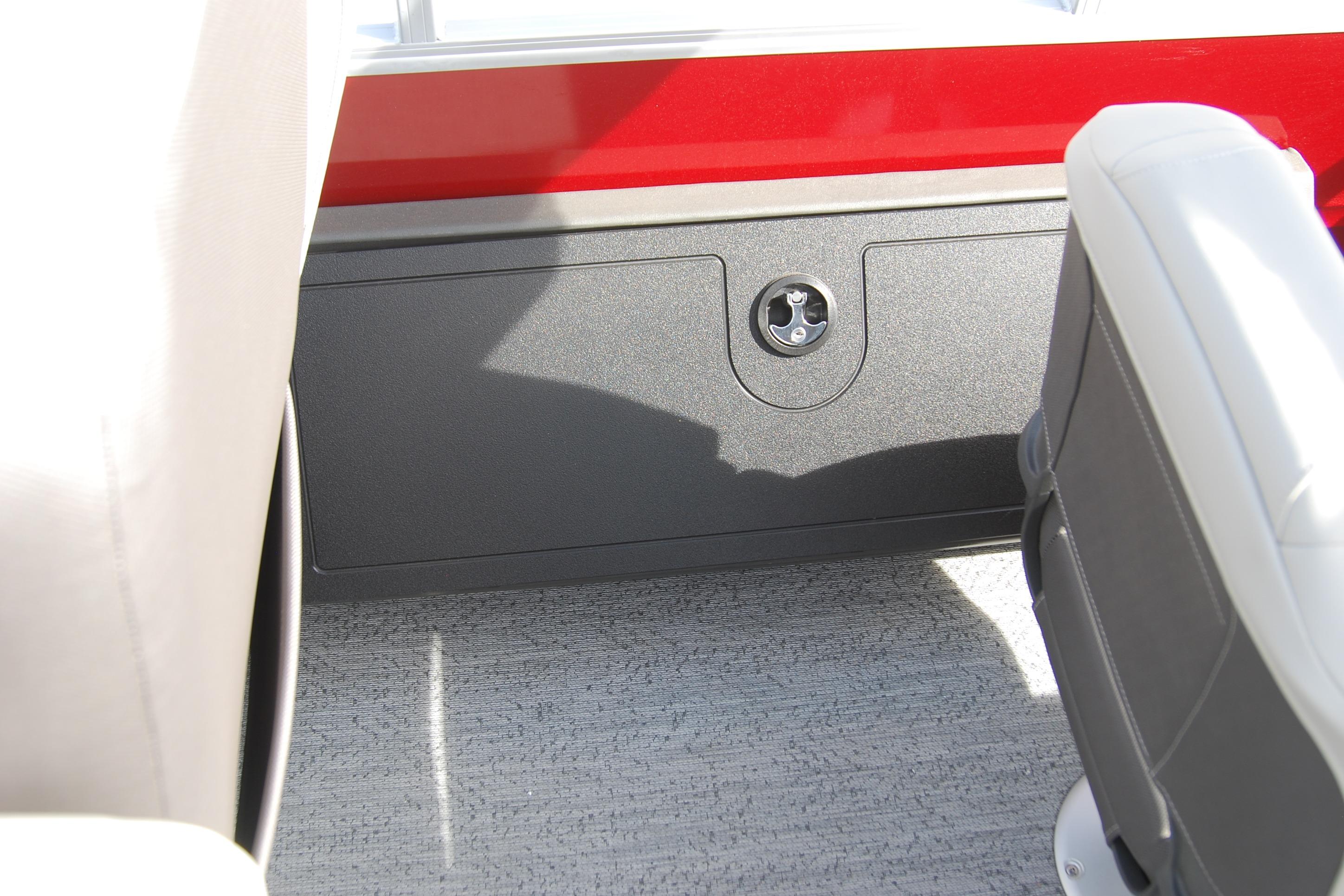 Interior view of 2026 Sun Tracker Fishin' Barge 22 XP3, featuring seating and storage compartment.