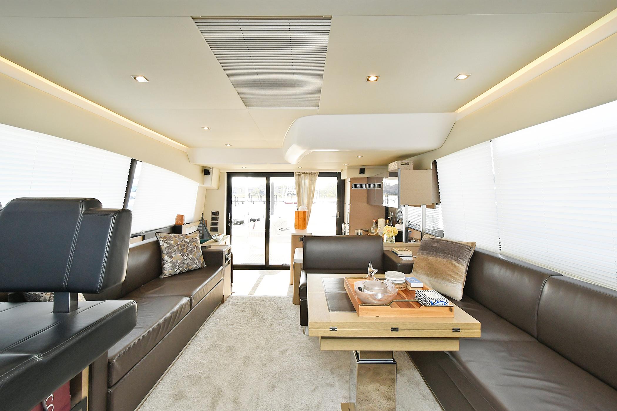 Luxurious interior of 2018 Prestige 560 Fly yacht with modern seating and elegant decor.