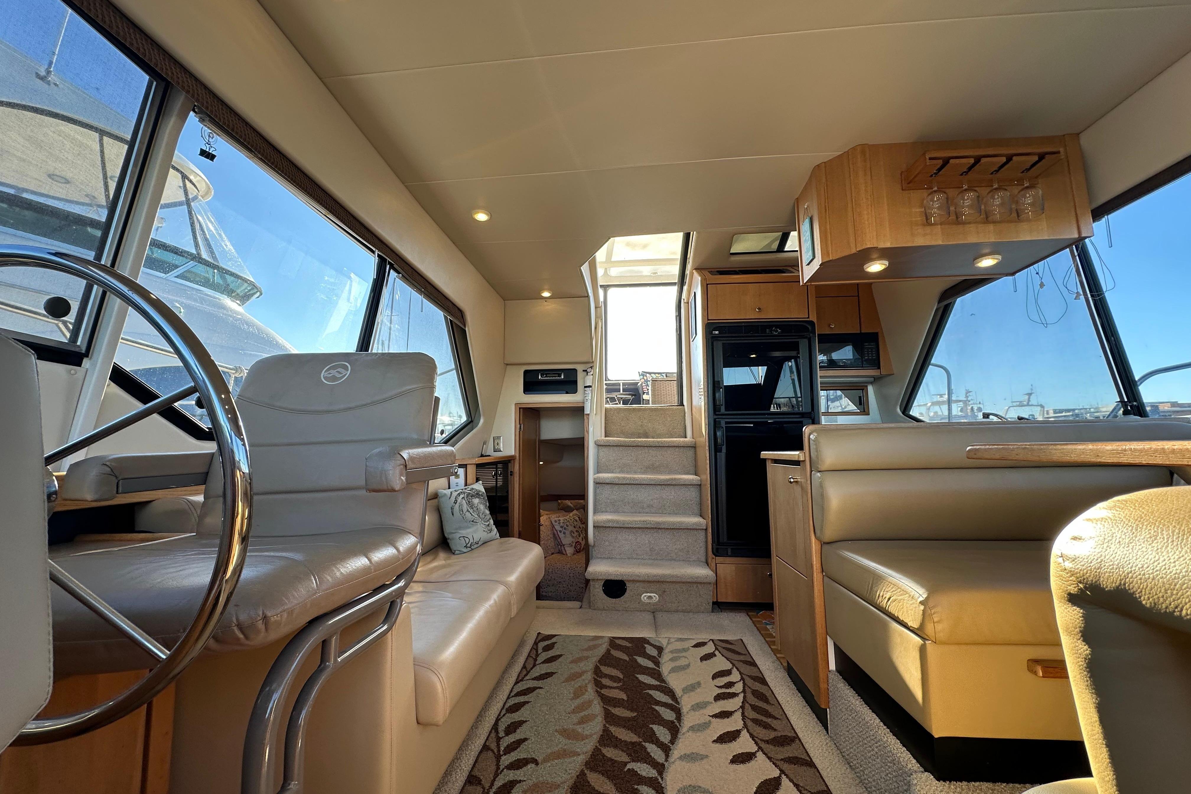 Interior of 2000 Bayliner 4087 Aft Cabin Motoryacht, featuring helm, seating, and dining area.
