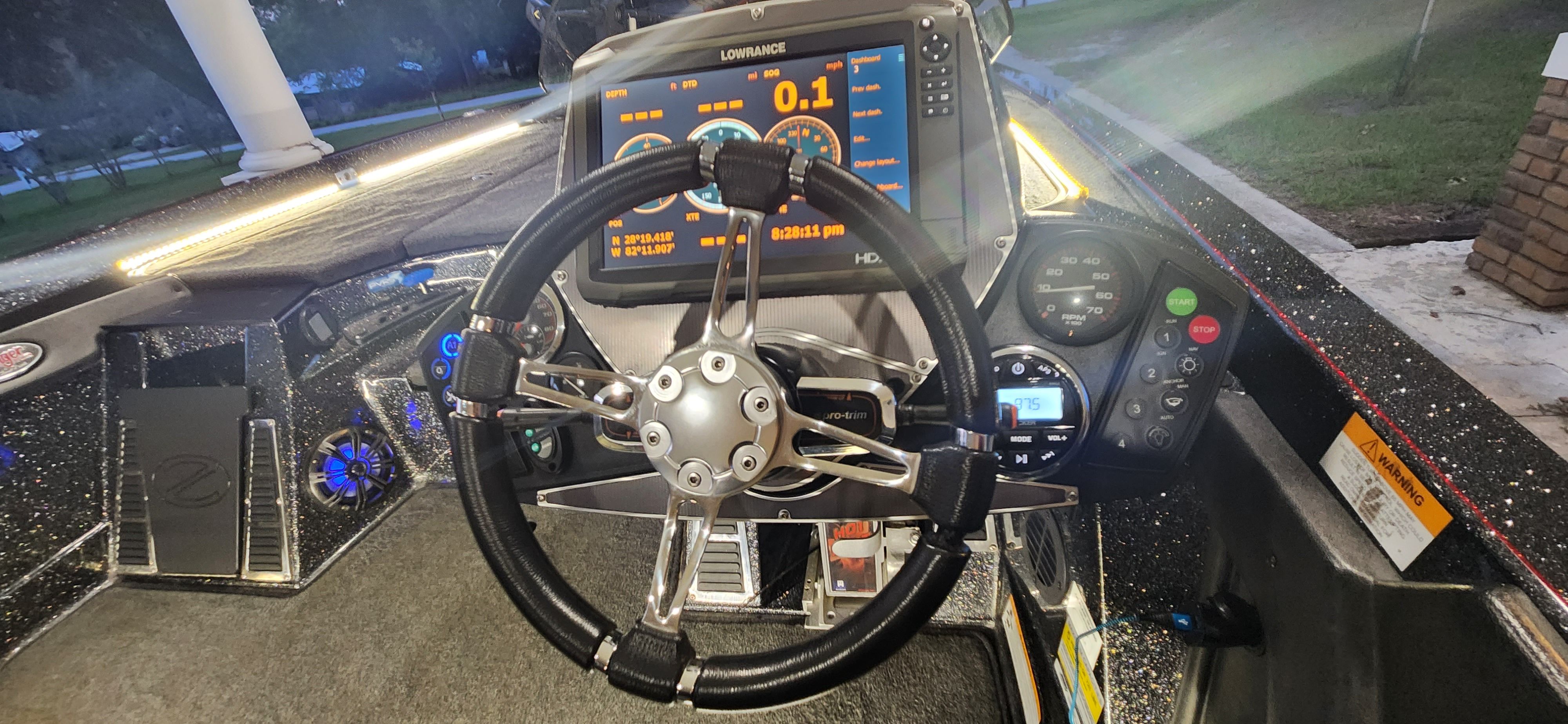 The image shows the cockpit of a 2017 Ranger Z520 Comanche boat with a modern steering wheel and instruments.