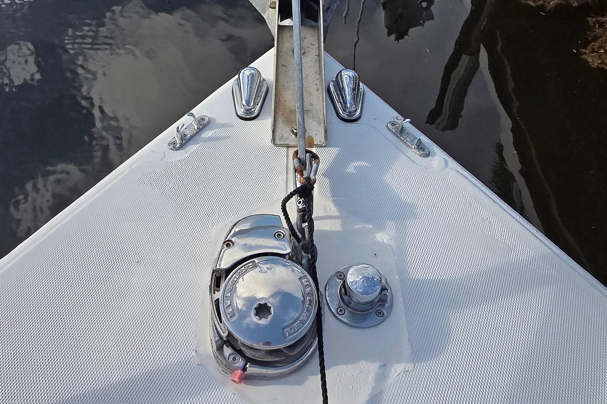 Bow of 2001 Jupiter 31 Cuddy boat with anchor winch and cleats.
