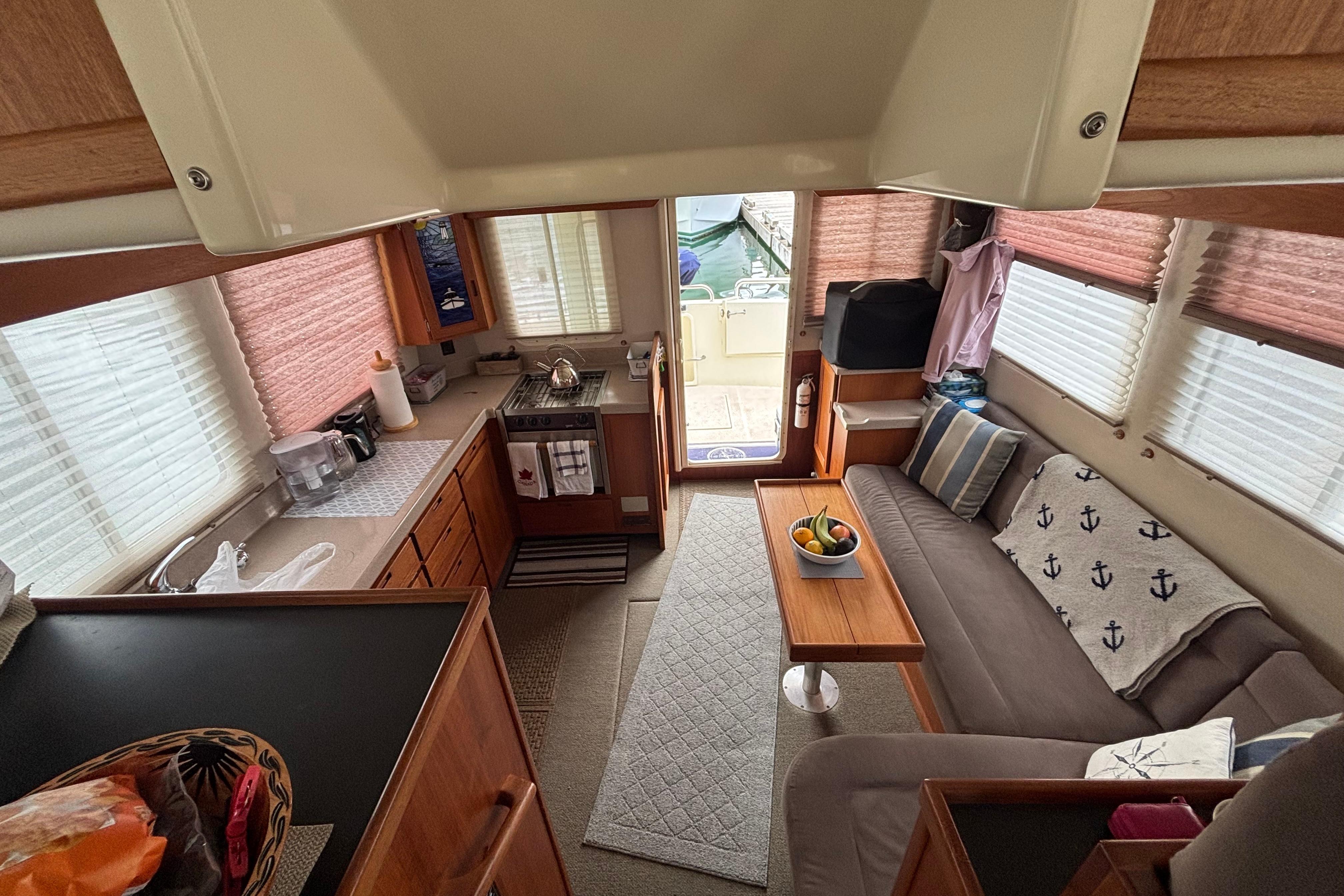 Interior of a 2004 Nordic Tug 37, featuring a cozy living area and kitchen.