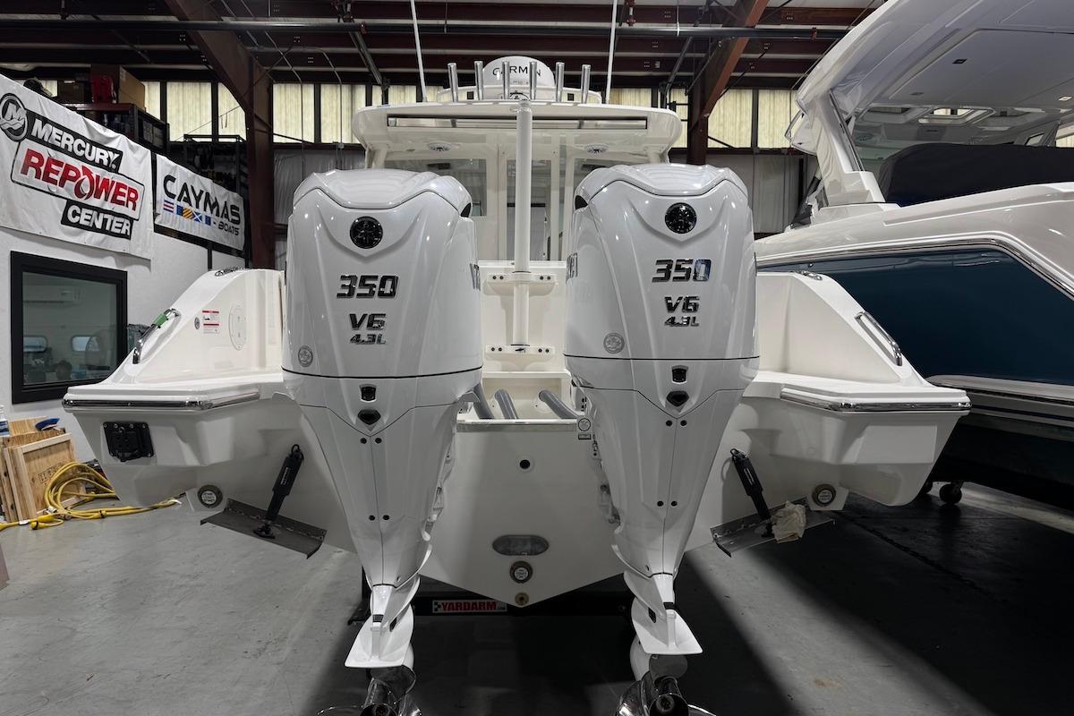 2026 Pursuit DC 326 Dual Console with twin 350 V6 engines in a showroom.