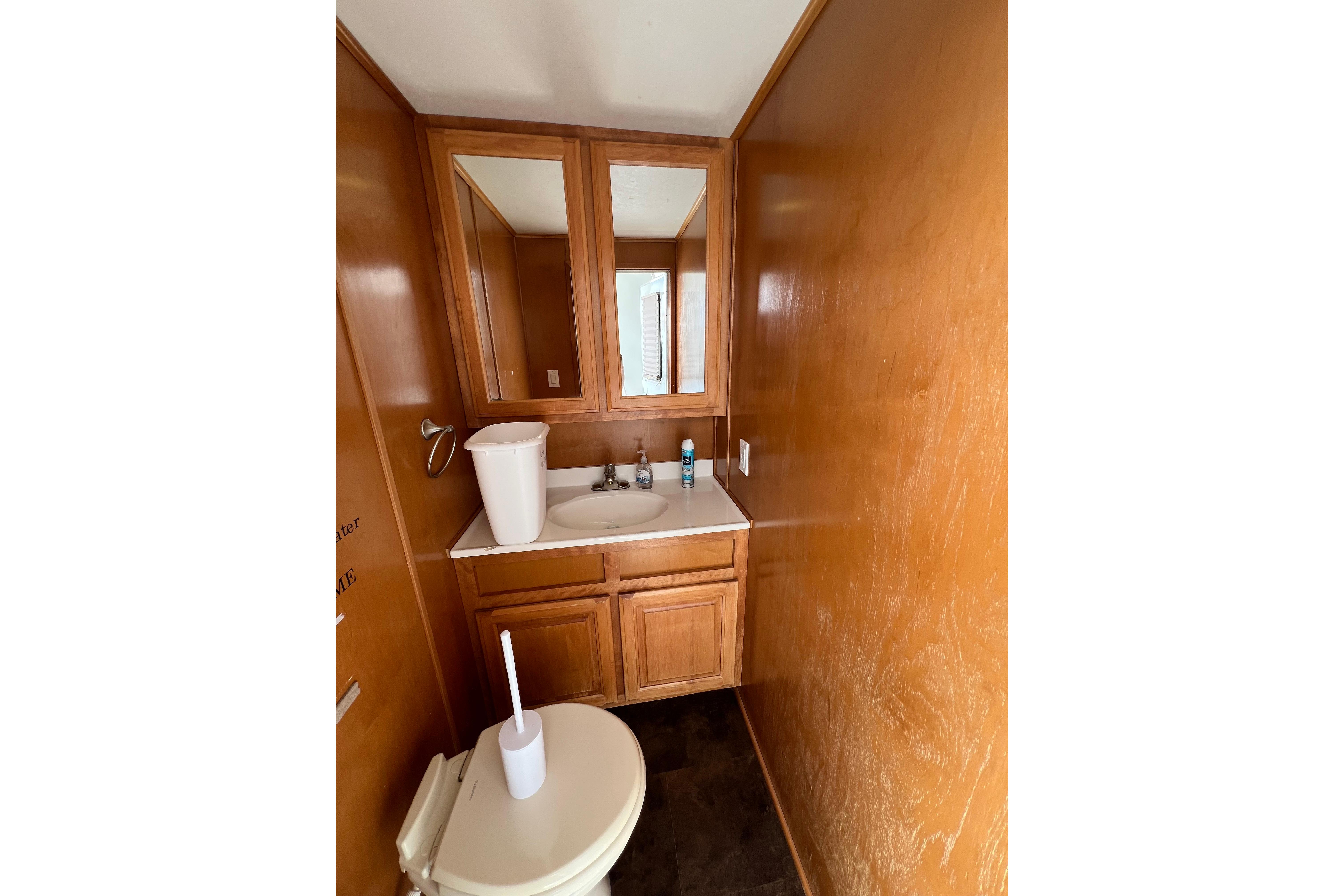 Bathroom interior of 2013 Destination Yacht Lotta Yachta with wooden cabinetry and mirror.
