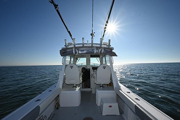 2026 Steiger Craft 255 Miami boat on open water under bright sun.