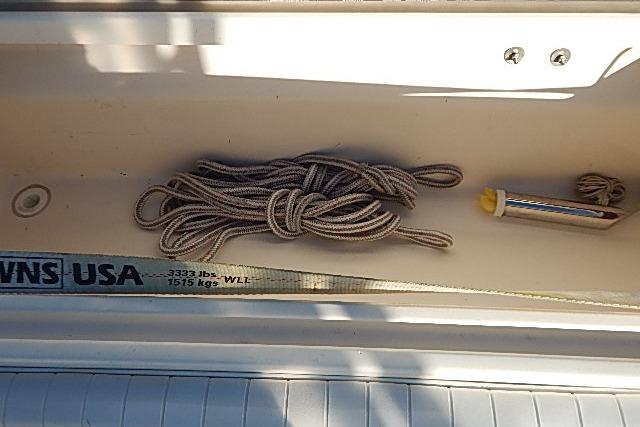 Coiled rope and tool in 2003 World Cat 270 EC boat compartment.
