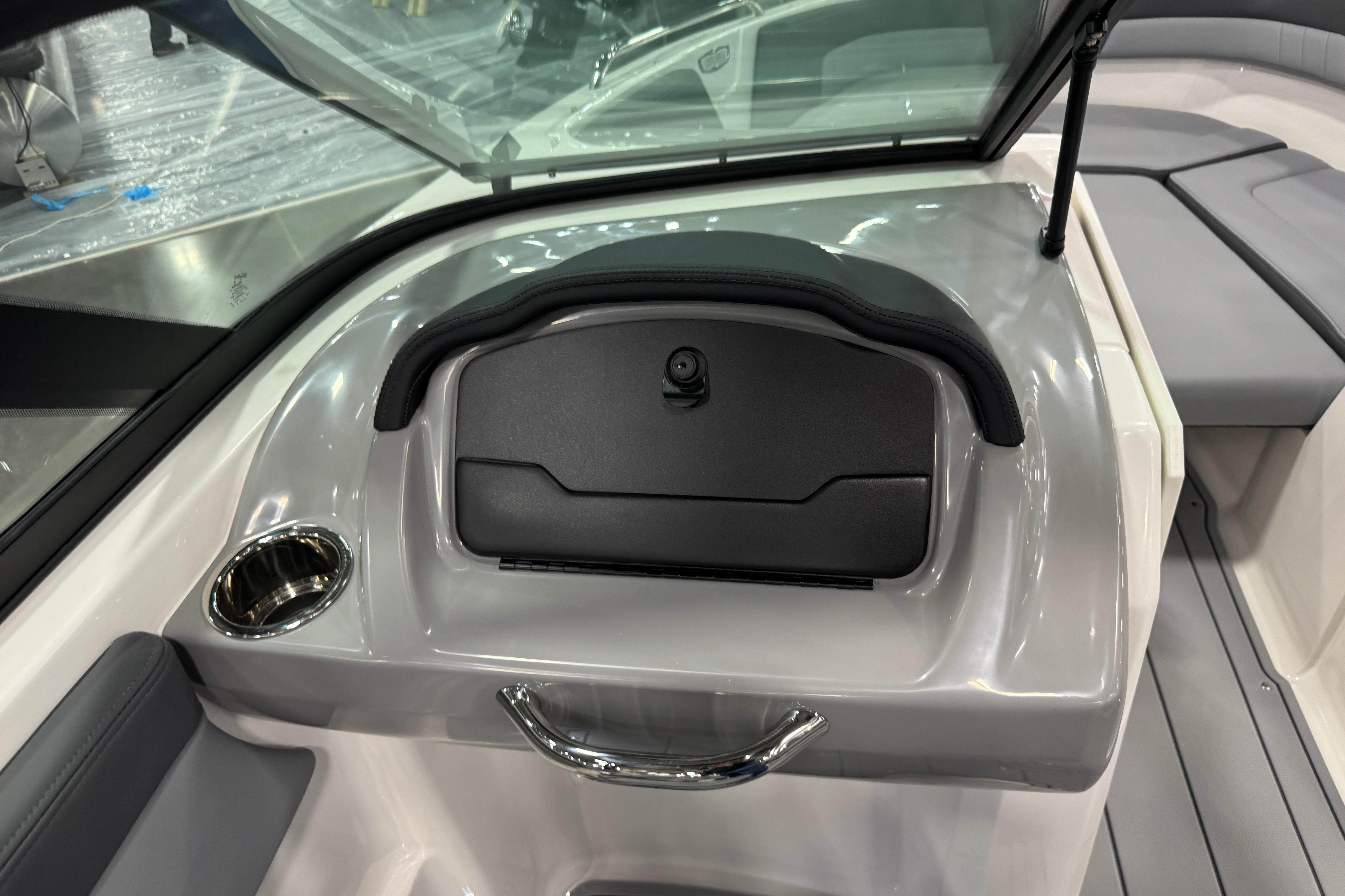 2026 Chaparral 23 SSi boat interior with glove compartment and cup holder.