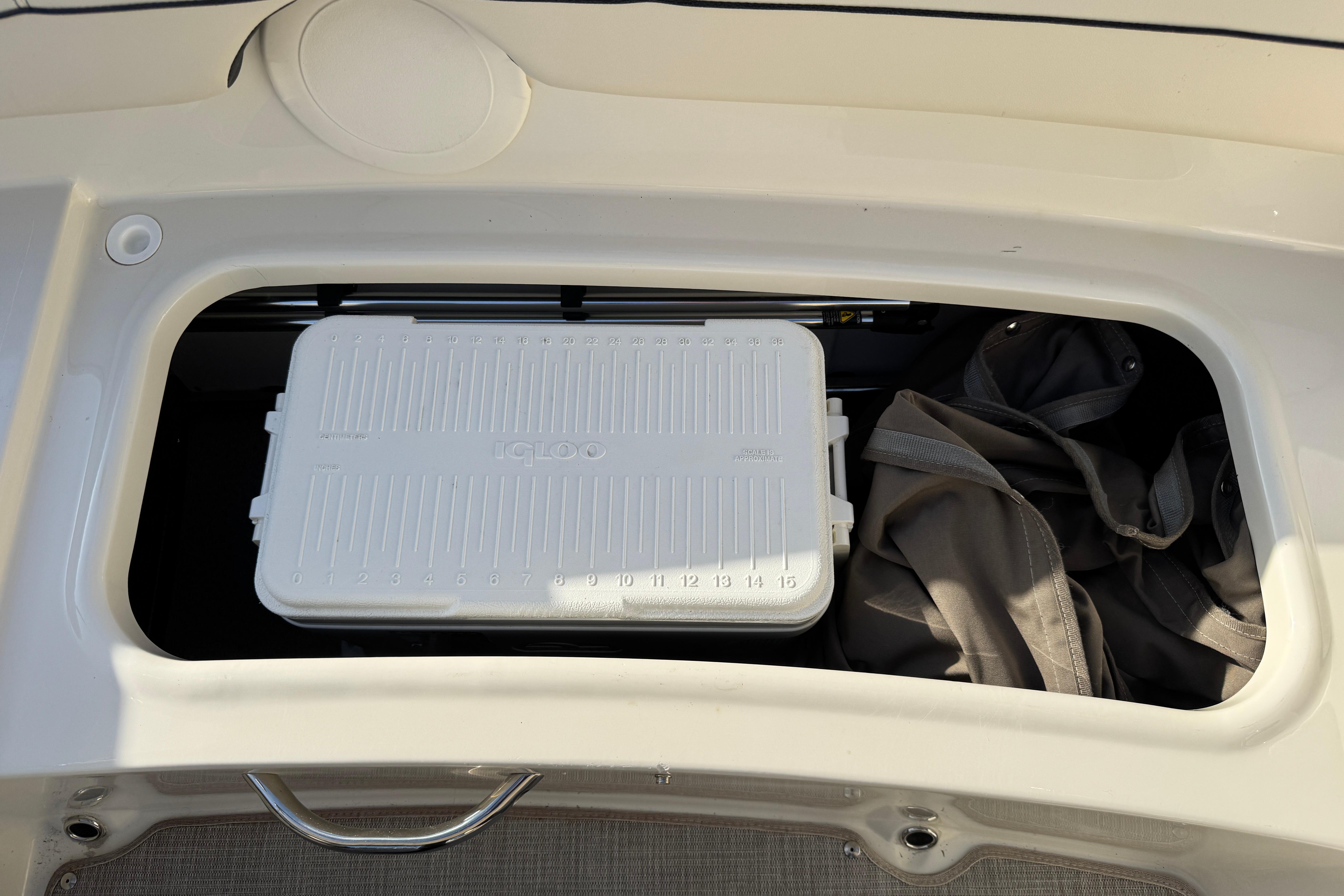 Storage compartment in 2022 Stingray 191 DC boat with cooler and bag.