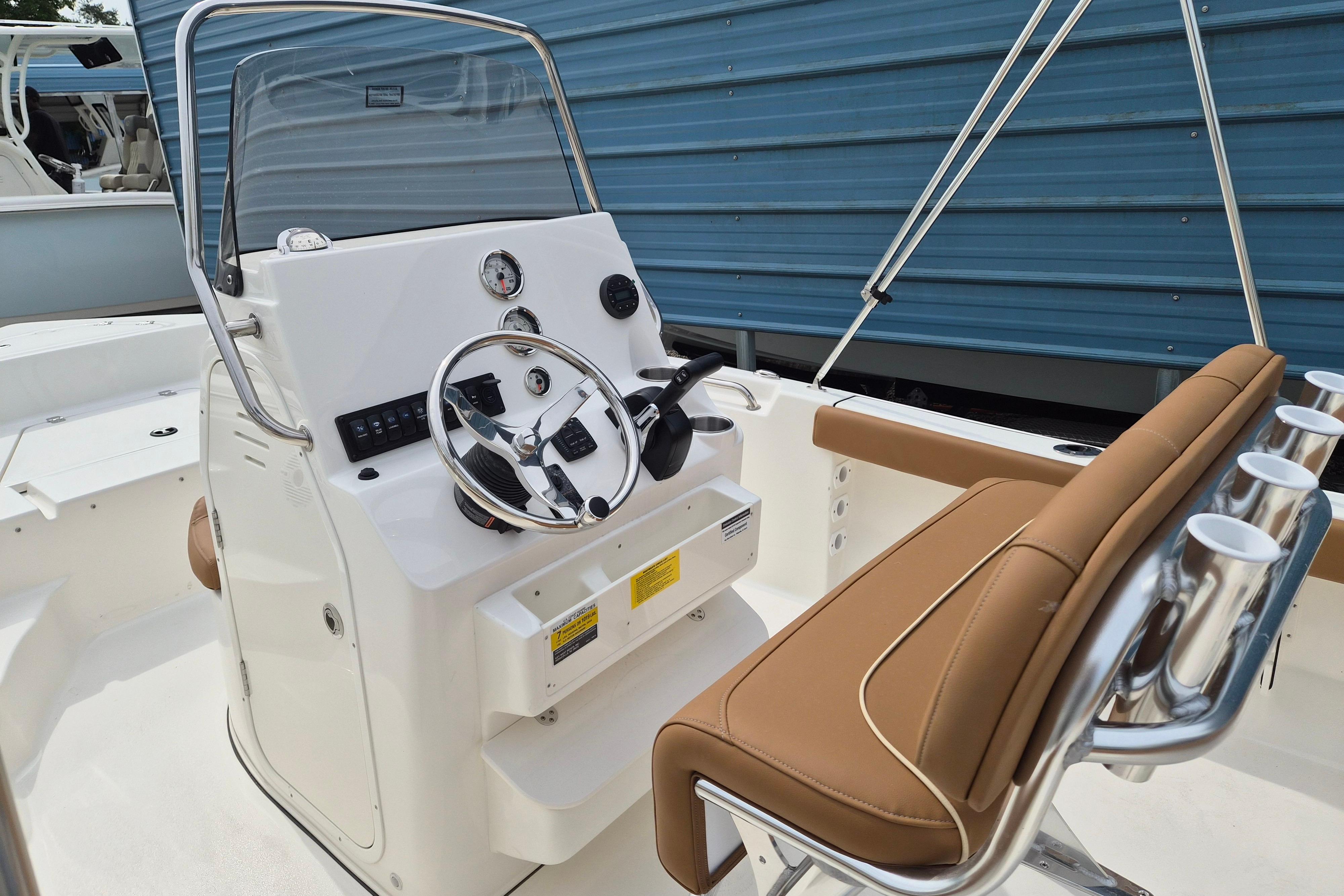 2026 Key West 189 FS boat interior with steering console and tan seating.