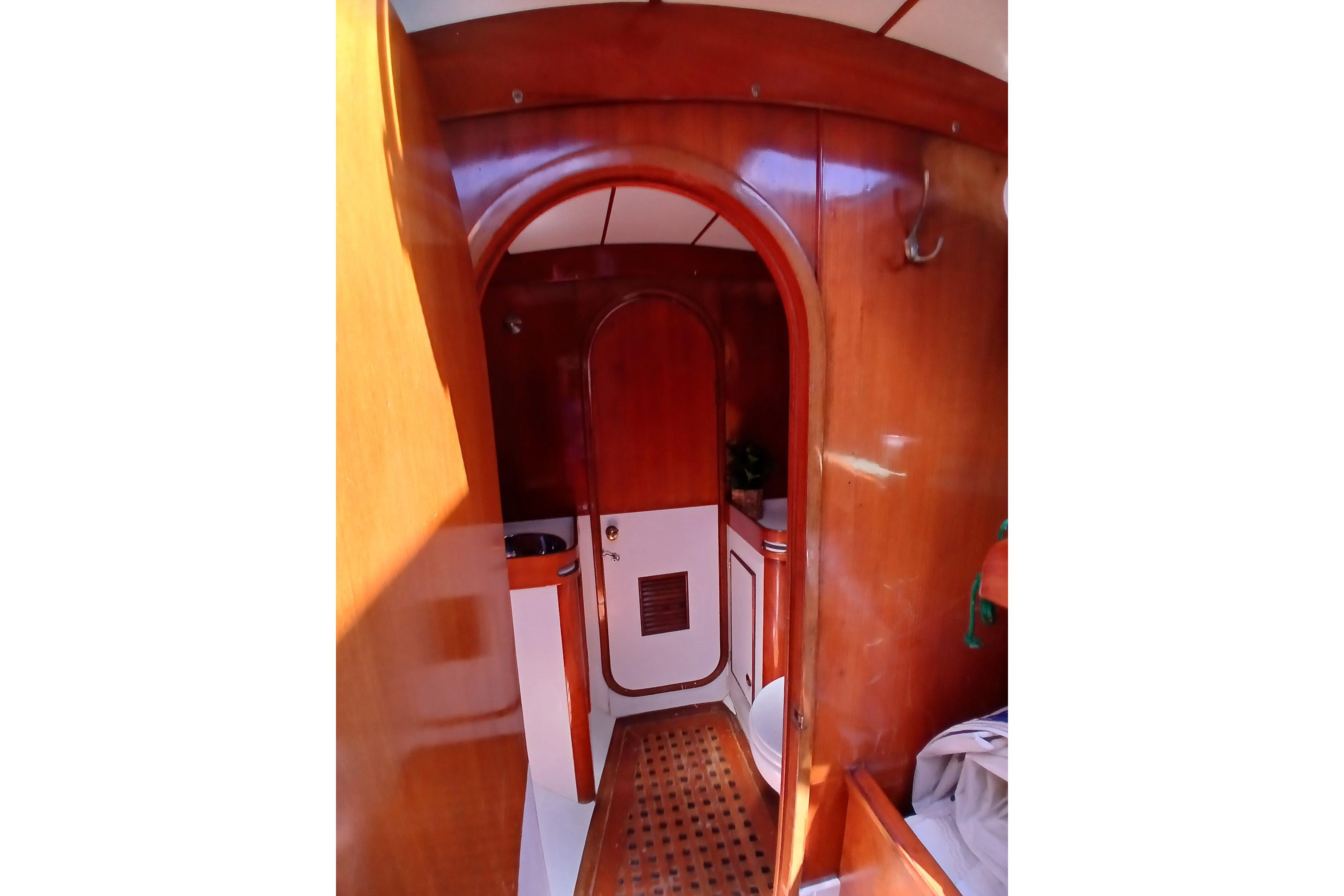 Interior of 1981 SKYE 51 yacht with wooden finishes and arched doorway.