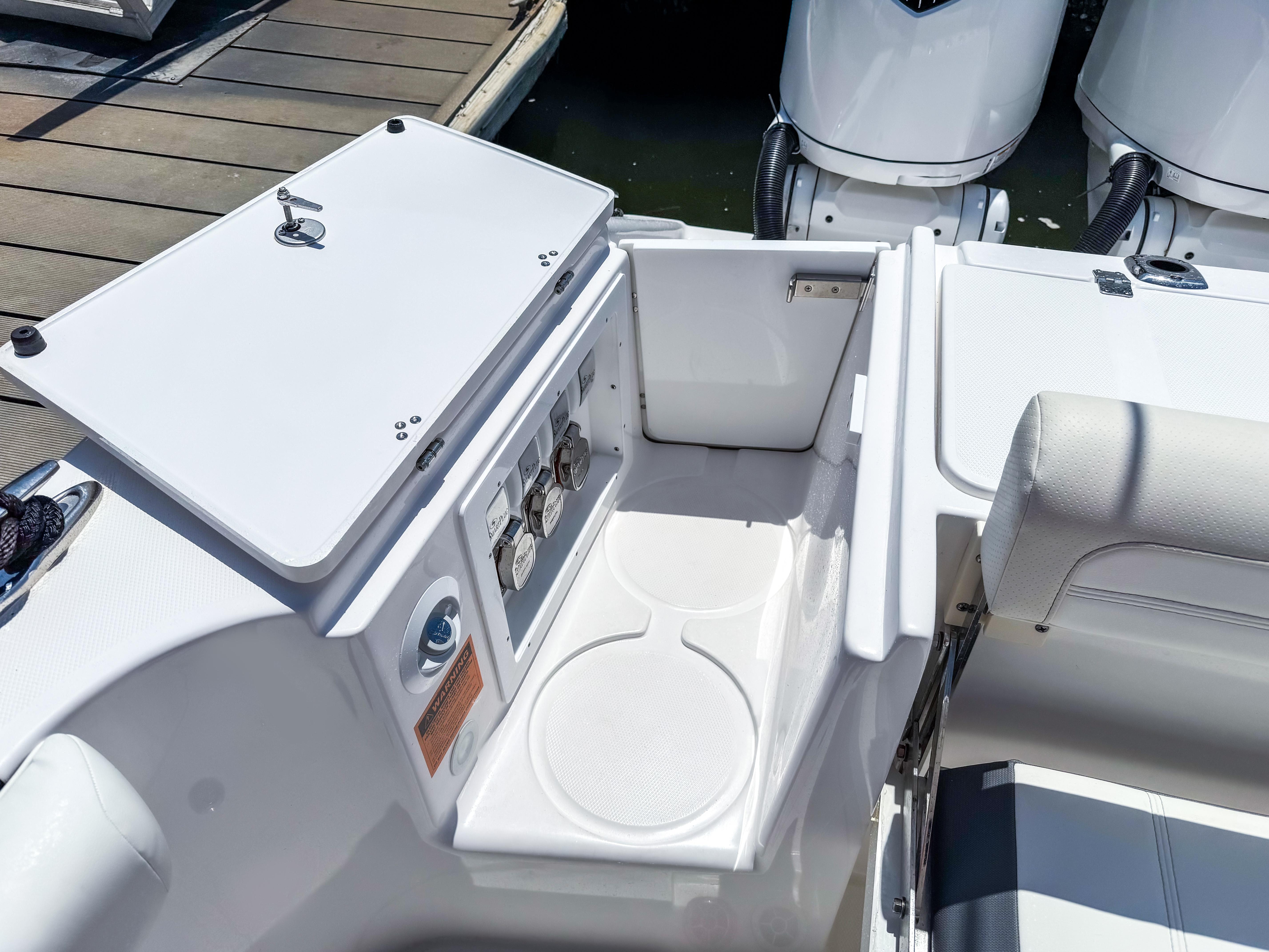 2025 Edgewater 370CC boat interior with storage compartment and seating area.