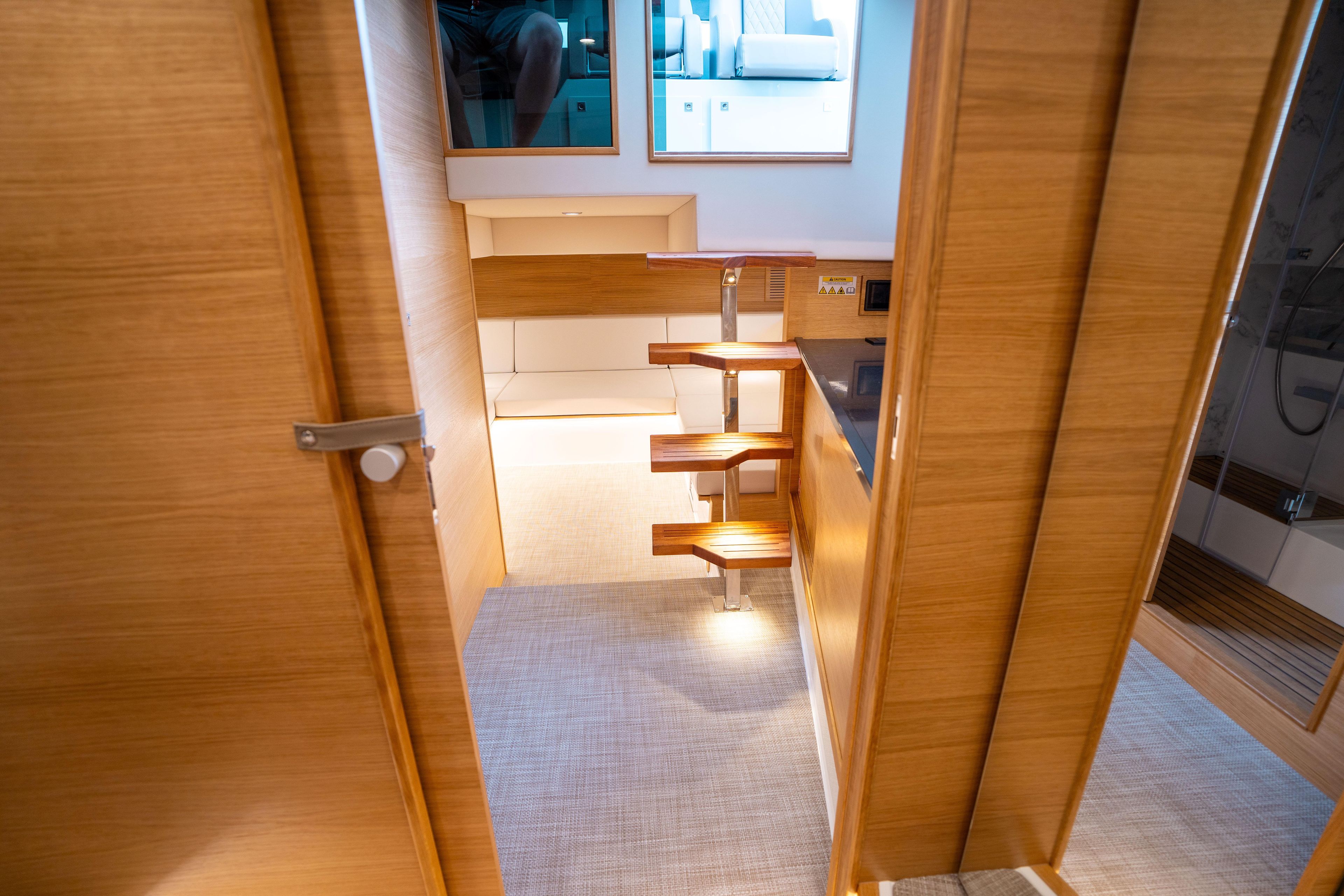 Interior of 2025 De Antonio Yachts D42 Open, featuring wooden stairs and modern design.