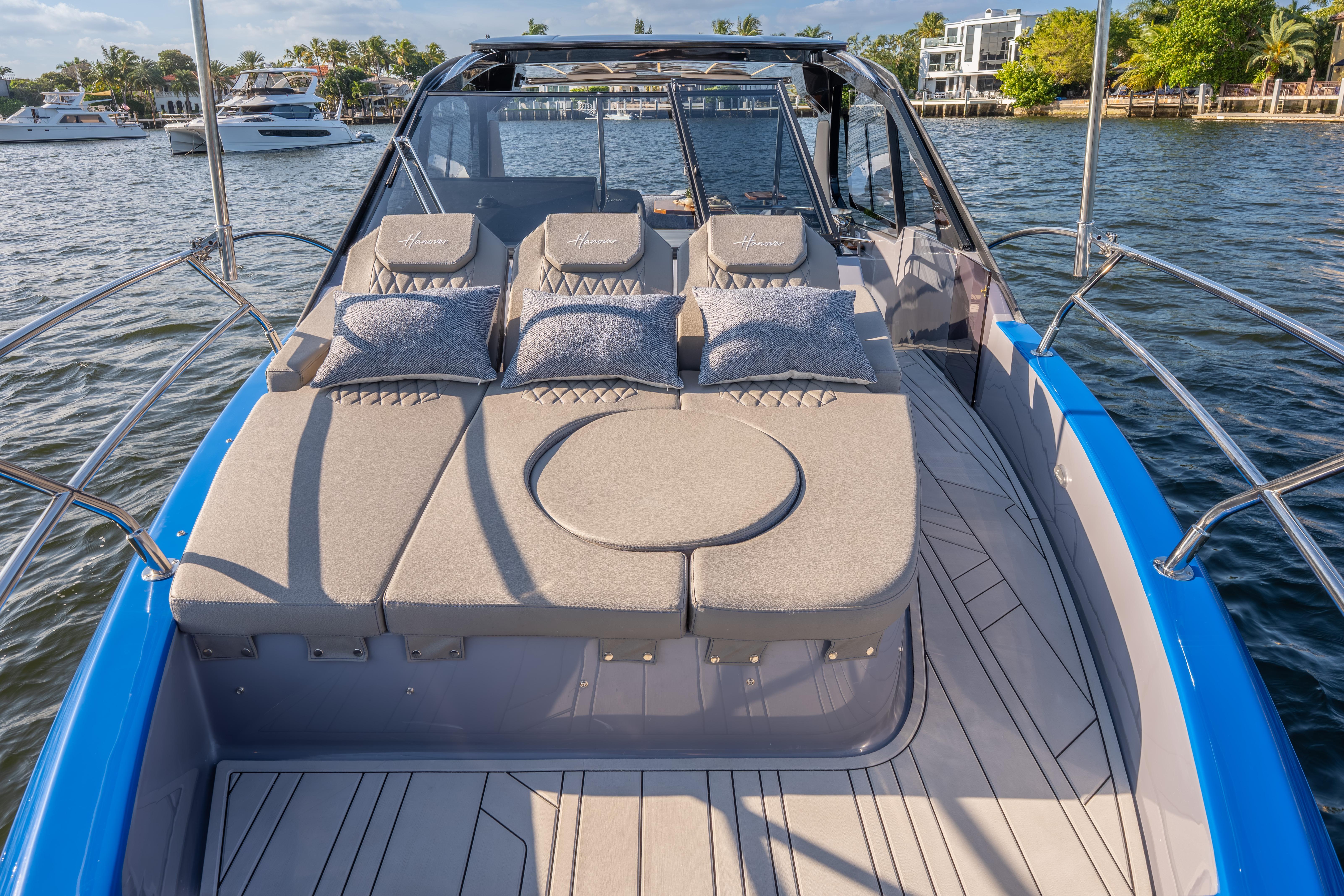 Luxurious 2026 Hanover 347 yacht with plush sunbathing area on a serene waterway.
