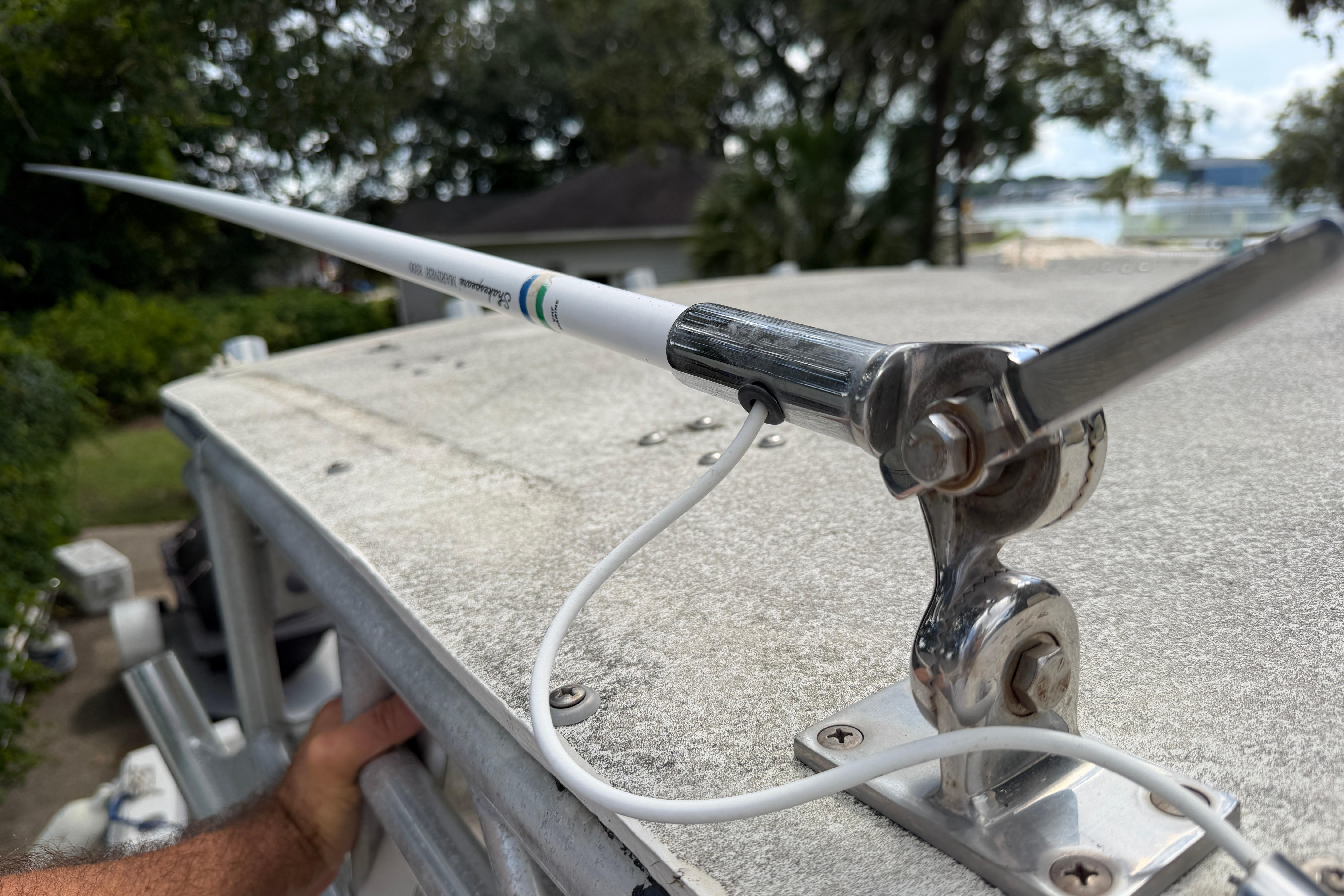 Antenna mounted on 1987 Grady-White Seafarer 226 boat, with lush greenery in the background.