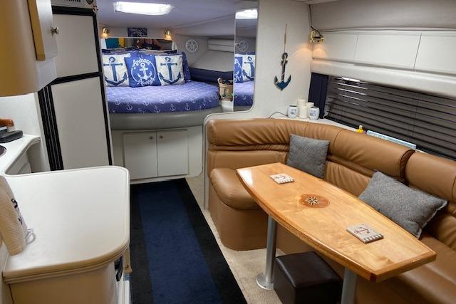 Interior of 1994 Cruisers Yachts 3675 Esprit with cozy seating and nautical decor.