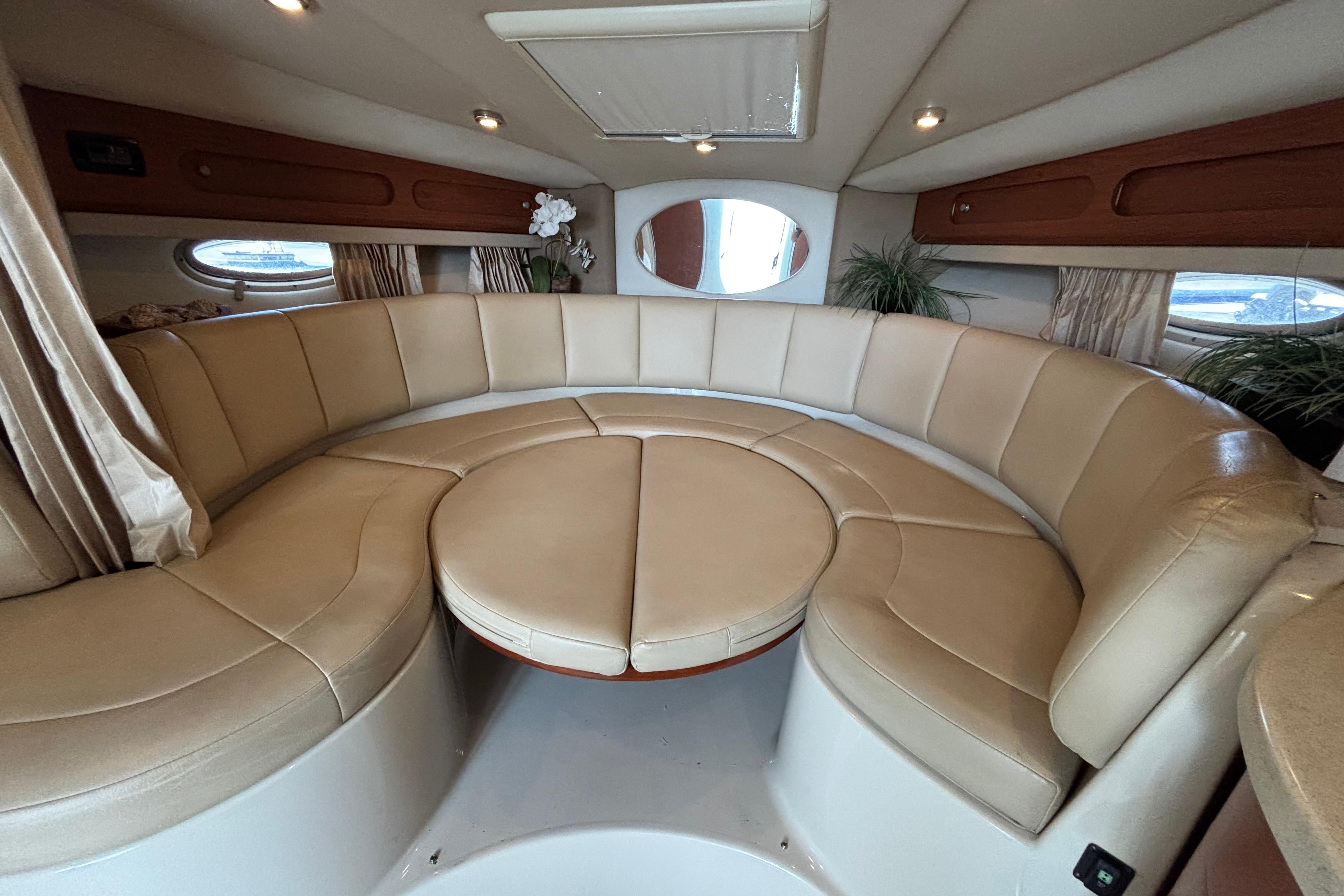 2004 Chaparral Signature 330 interior with beige leather seating and elegant decor.
