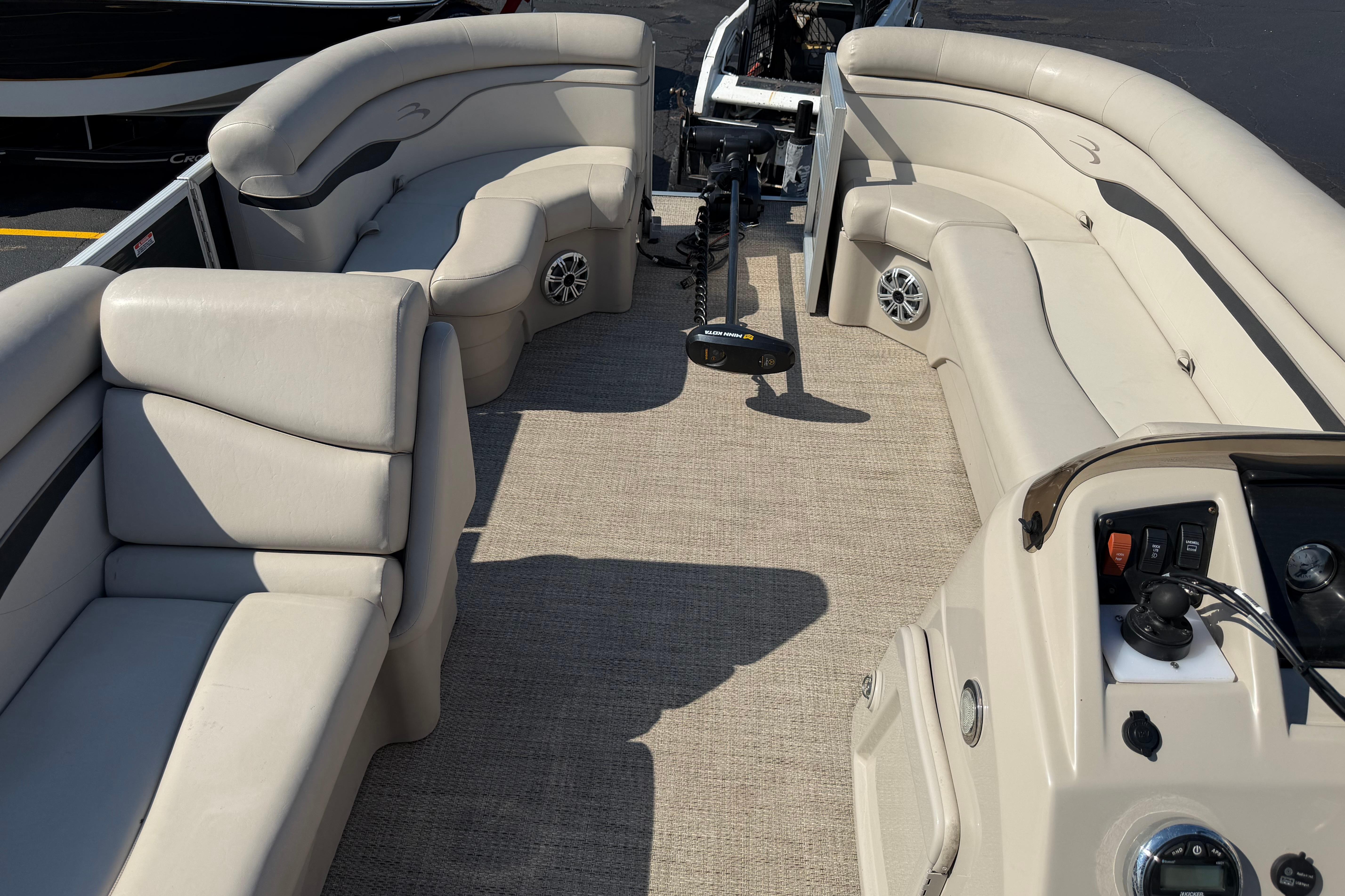 2018 Bennington 21 SF pontoon boat interior with beige seating and control panel.