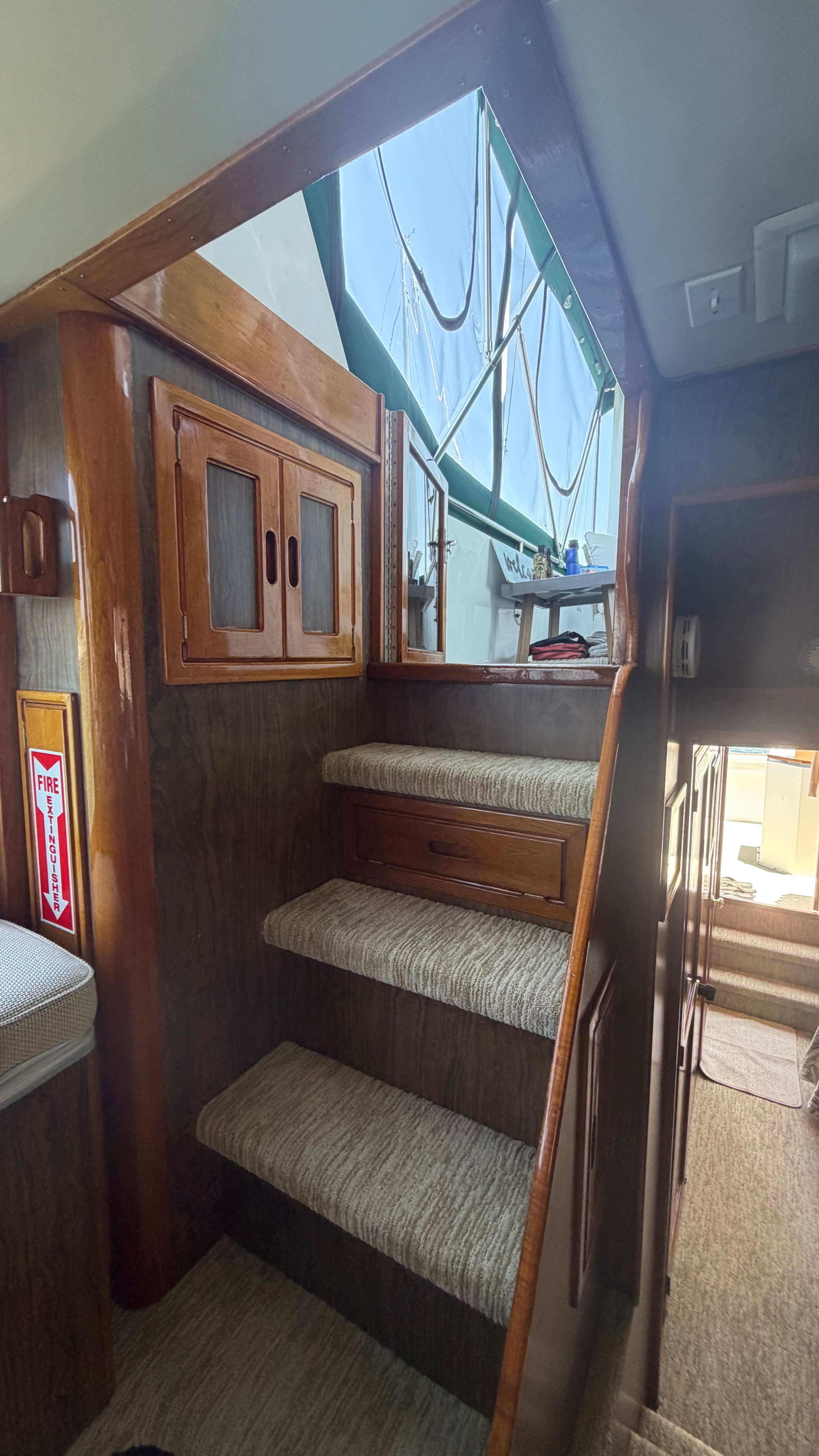 Interior of a 1966 Drake Yachtfisher with stairs and wood paneling.
