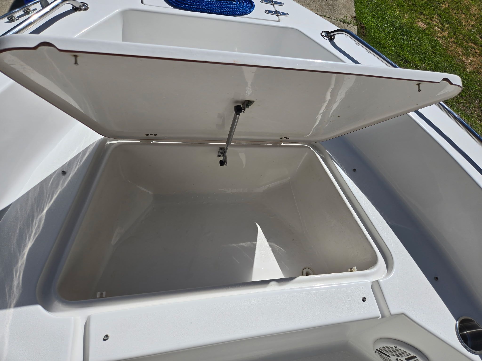 Open storage compartment on a 2012 Sea Hunt Triton 188 boat.