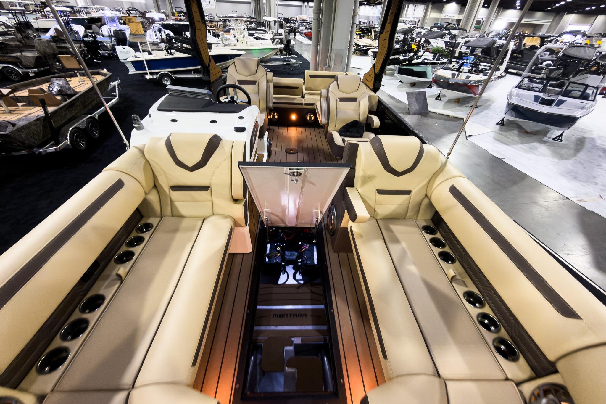 Luxurious interior of 2026 Montara Surf Boss EVO SLDH 25' boat at a showroom.