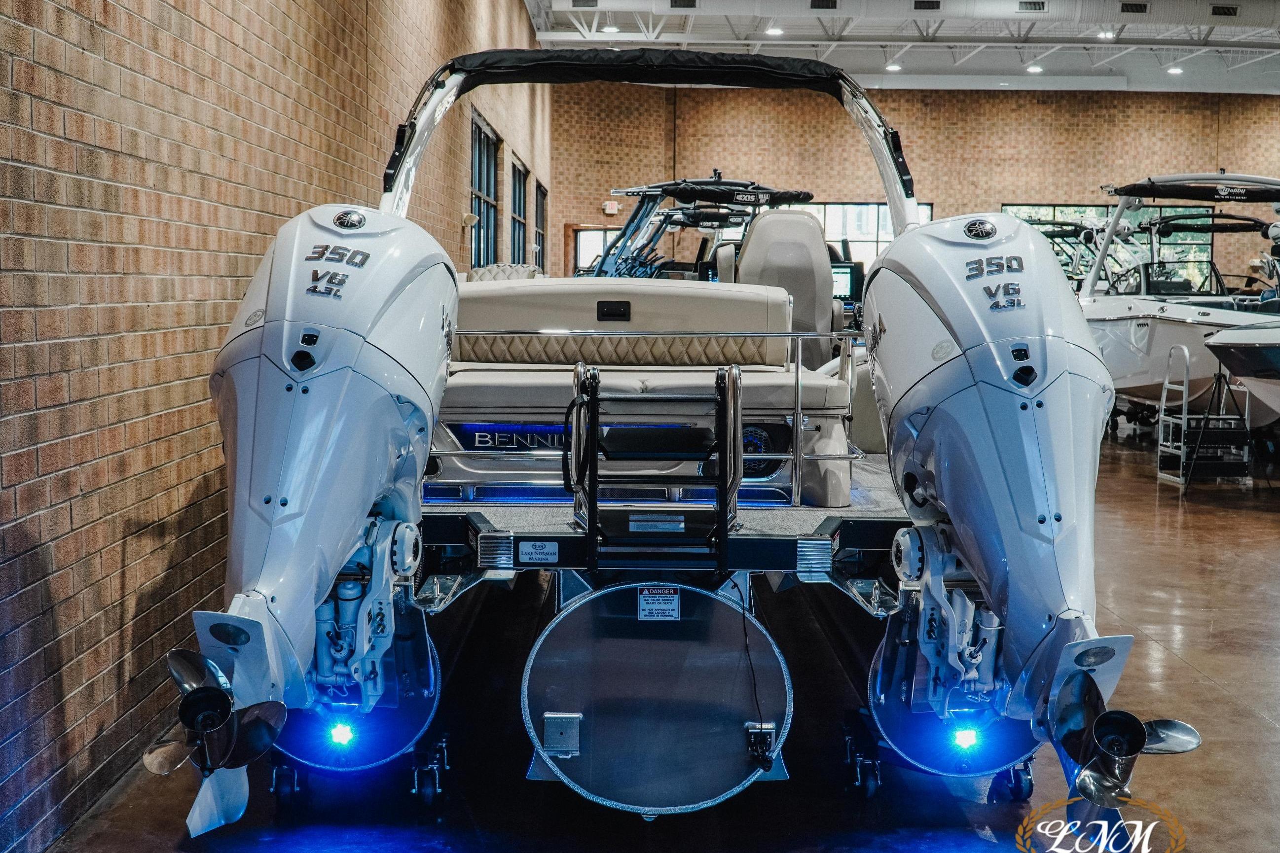 2026 Bennington 27QXSBAT2 boat with dual 350 V6 engines in showroom.