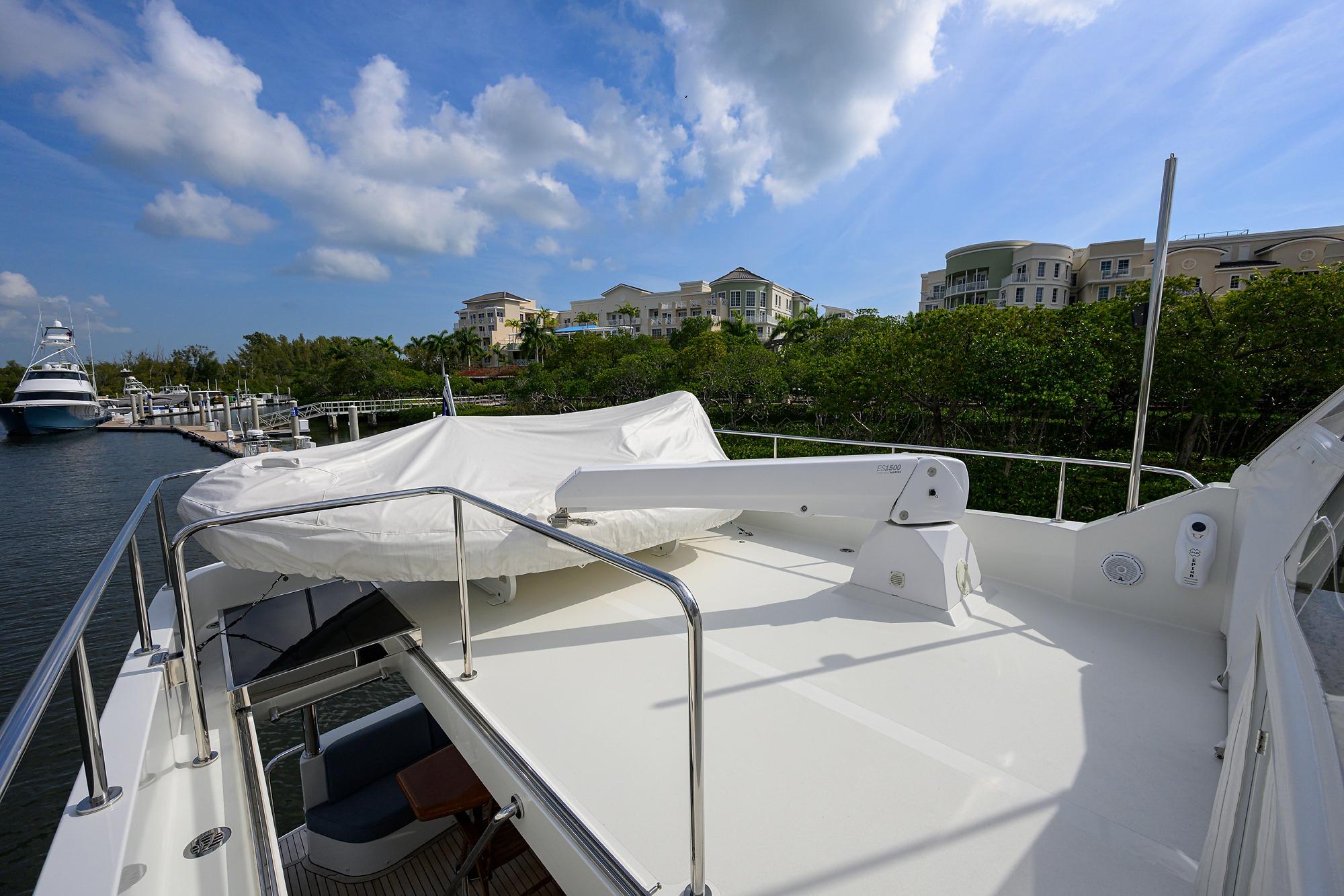 Luxurious 2016 Ocean Alexander 72 Pilothouse yacht docked near waterfront homes.