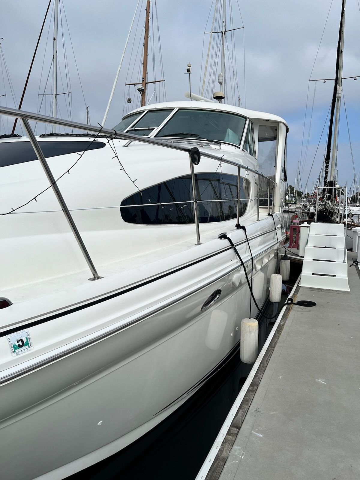 A 2004 Sea Ray Sedan Bridge docked. It features a sleek, white design.