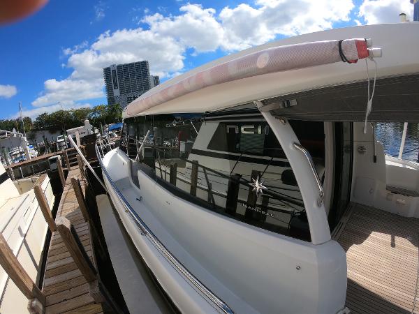 2017 Jeanneau NC 11 docked at a marina under a blue sky.