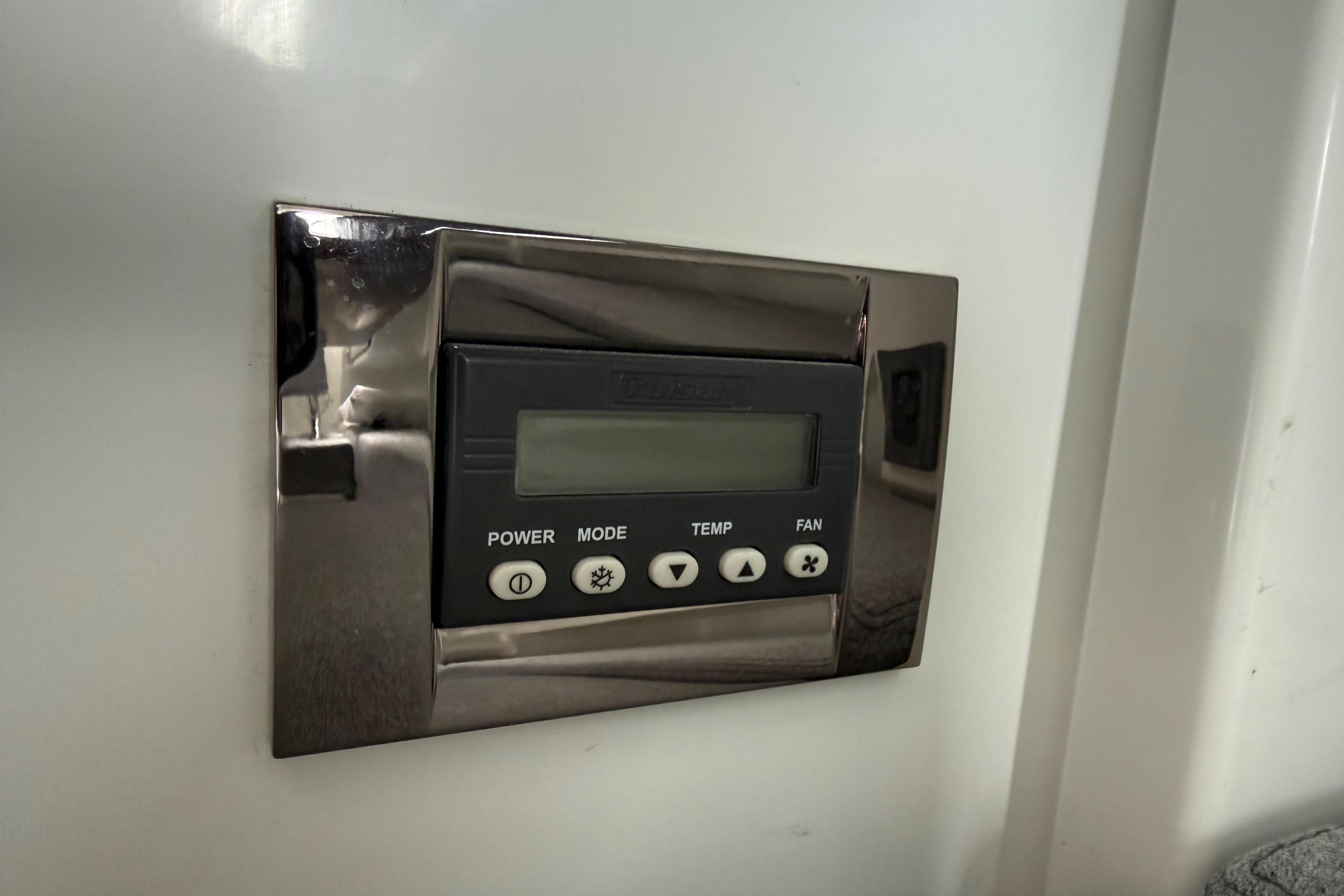 Control panel on a 2019 Beneteau Antares 23 boat, featuring power and temperature settings.