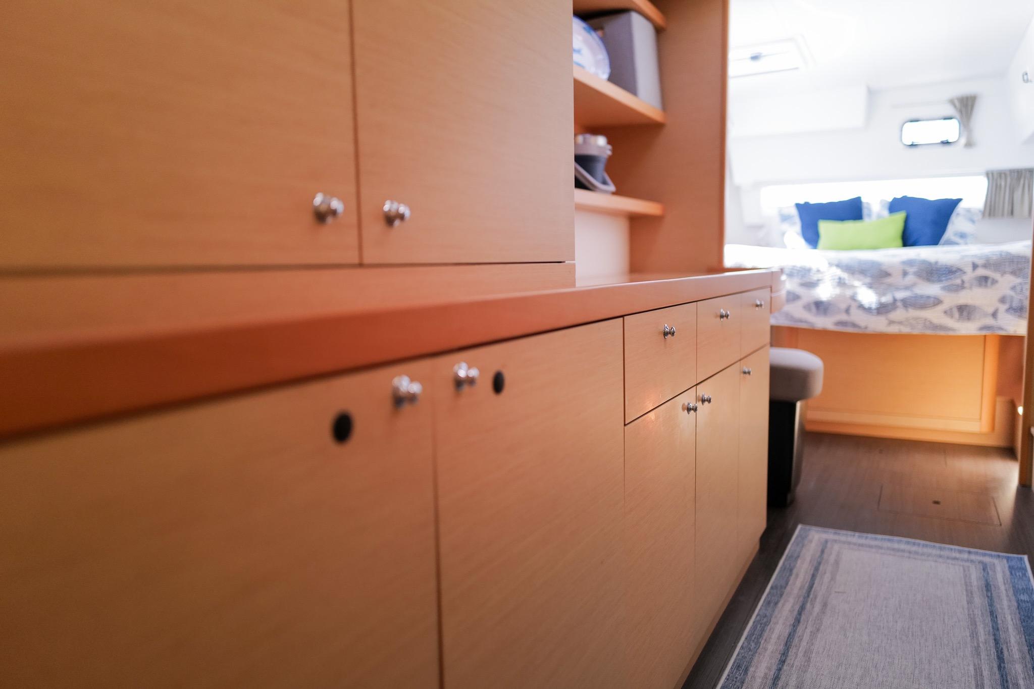 Interior of 2018 Lagoon 42 yacht with wooden cabinets and cozy bedroom.