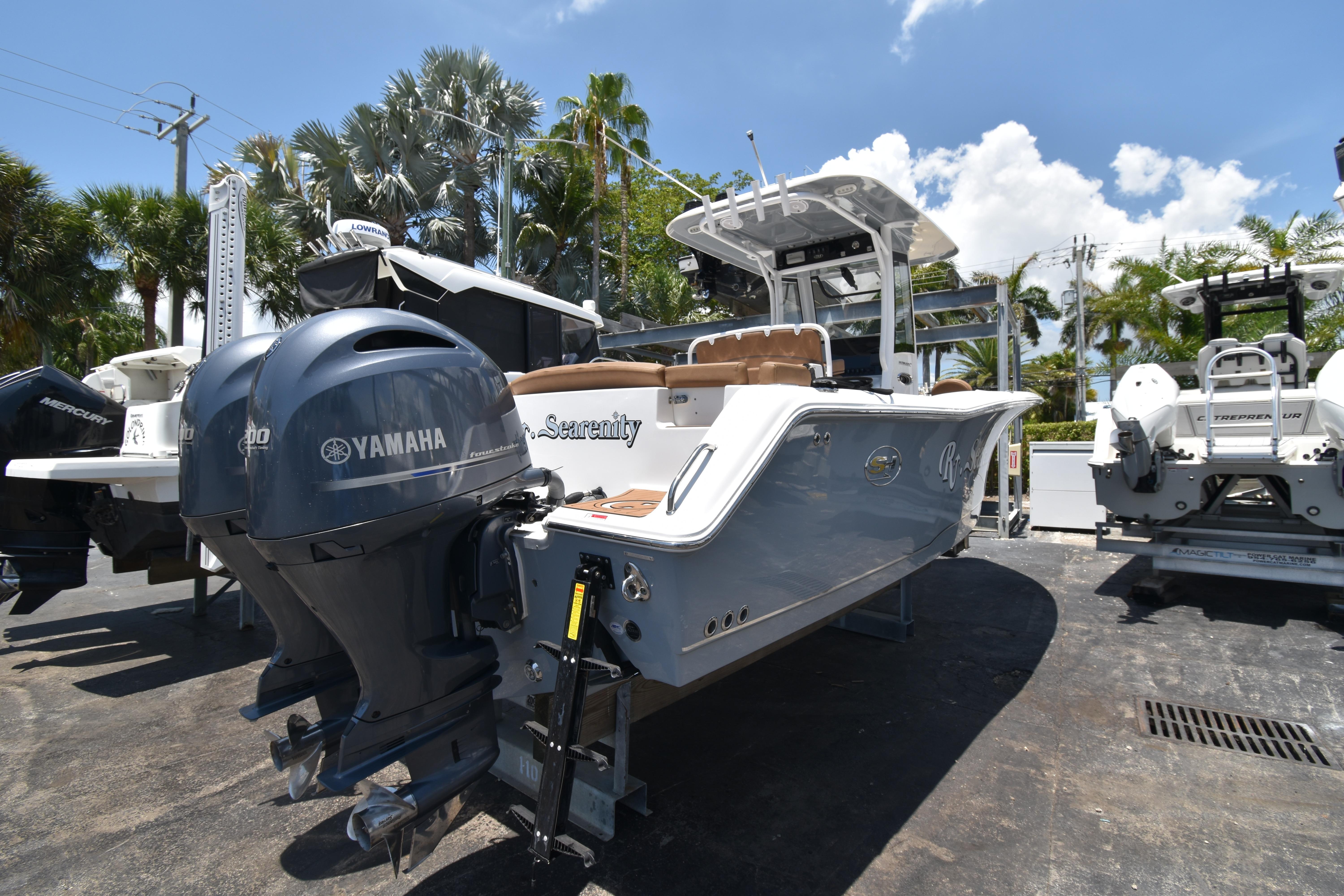 2020 Sea Hunt Ultra 275 SE boat with Yamaha engines, parked outdoors under a clear sky.