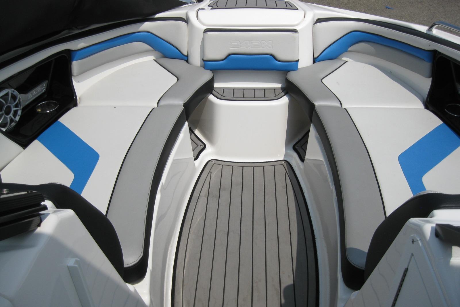 2018 Yamaha Boats 242X E-Series interior with gray and blue seating, sleek design.