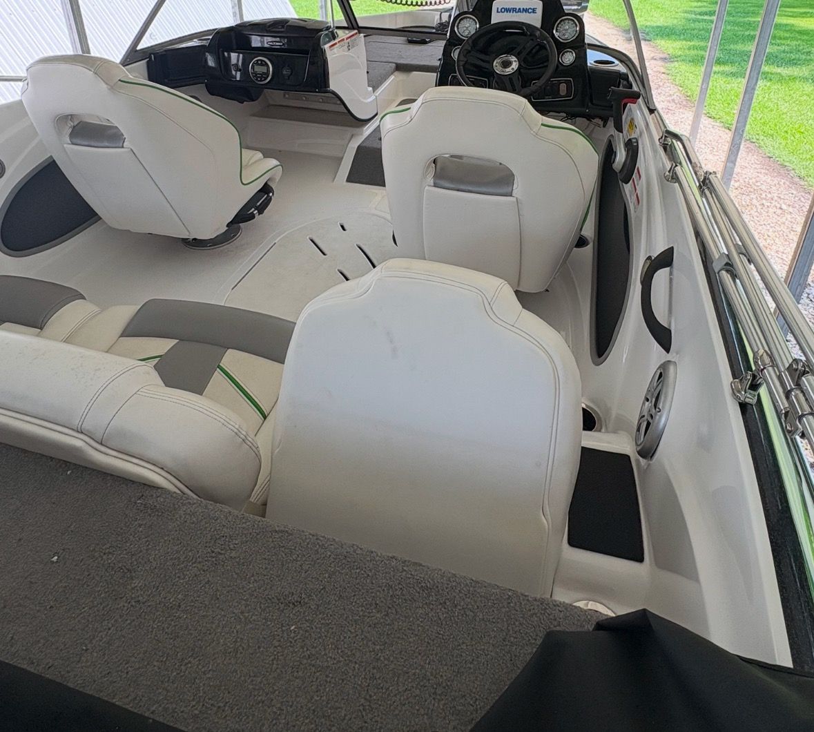 Interior of a 2021 Nitro Z19 Sport boat with white seats and a helm station.