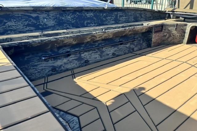 2026 Tracker Grizzly 1756 T Marsh boat interior with camouflage design and tan flooring.