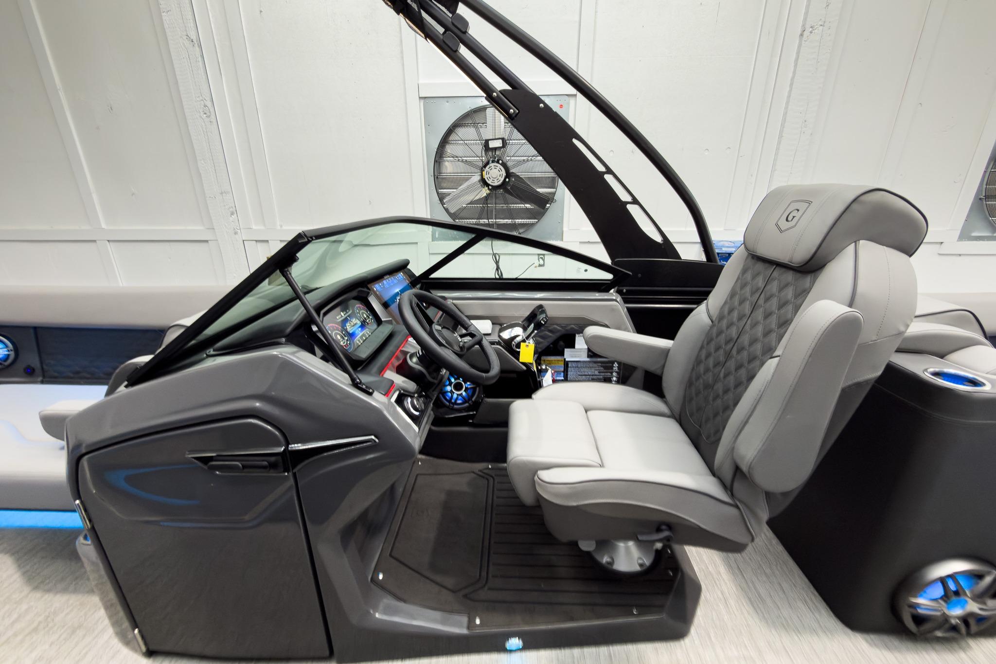 2026 Godfrey Sanpan 27' Tritoon helm with luxurious seating and advanced controls.