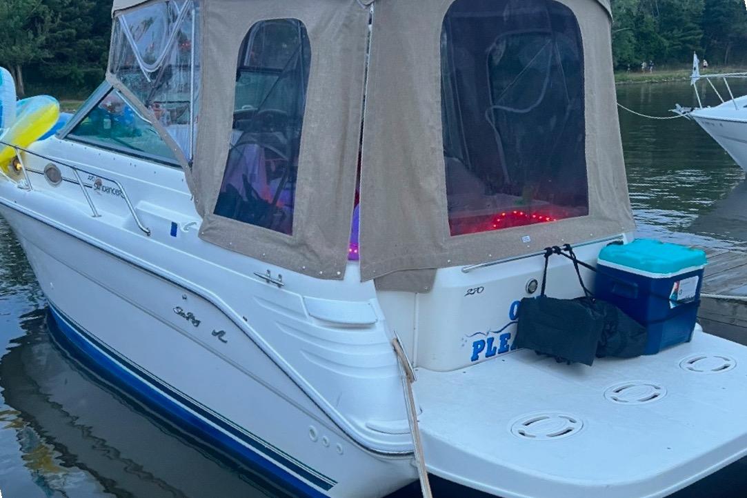 1997 Sea Ray 270 Sundancer boat docked with canopy and accessories.