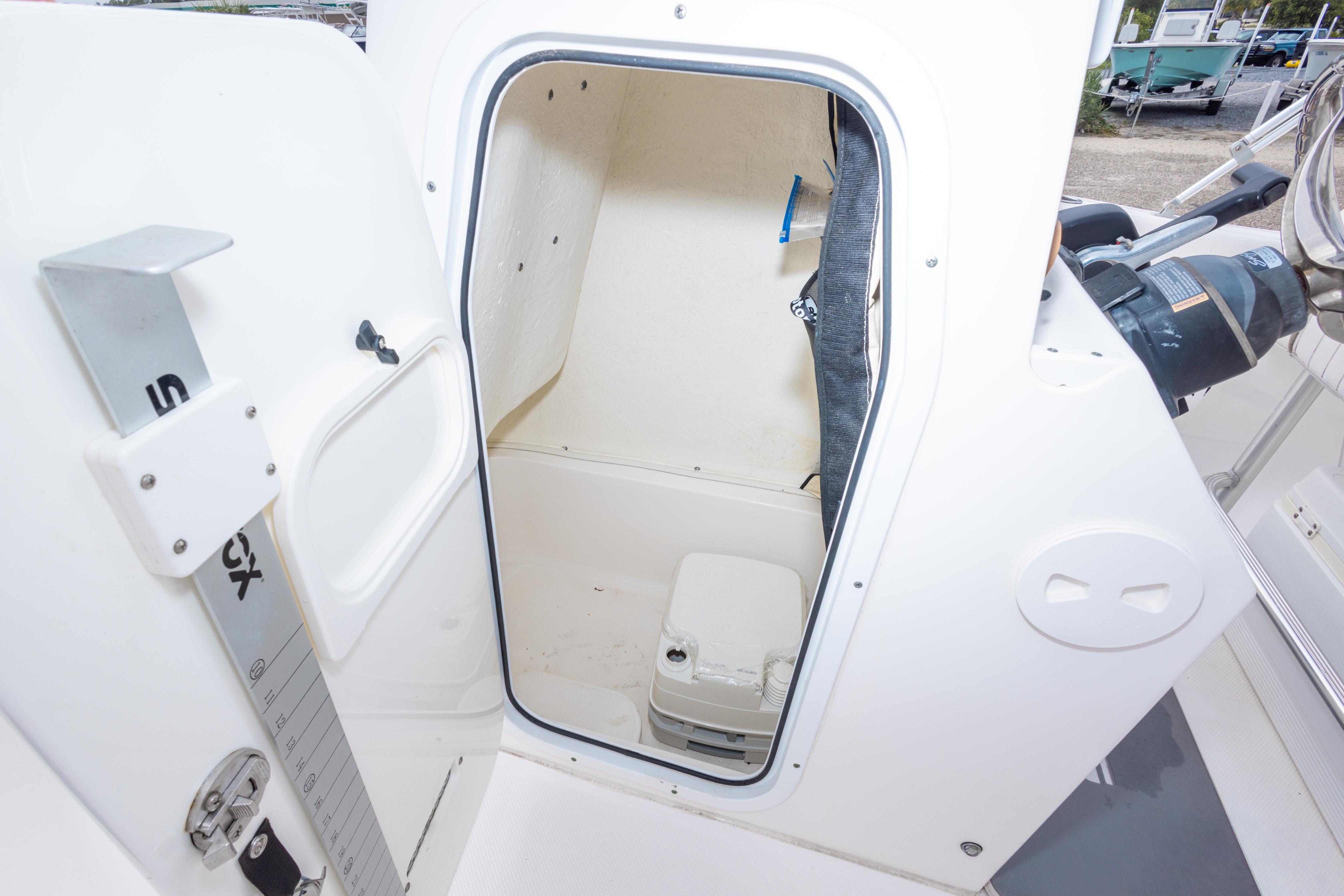 2014 Sea Fox 209 Commander boat interior with open storage compartment and portable toilet.