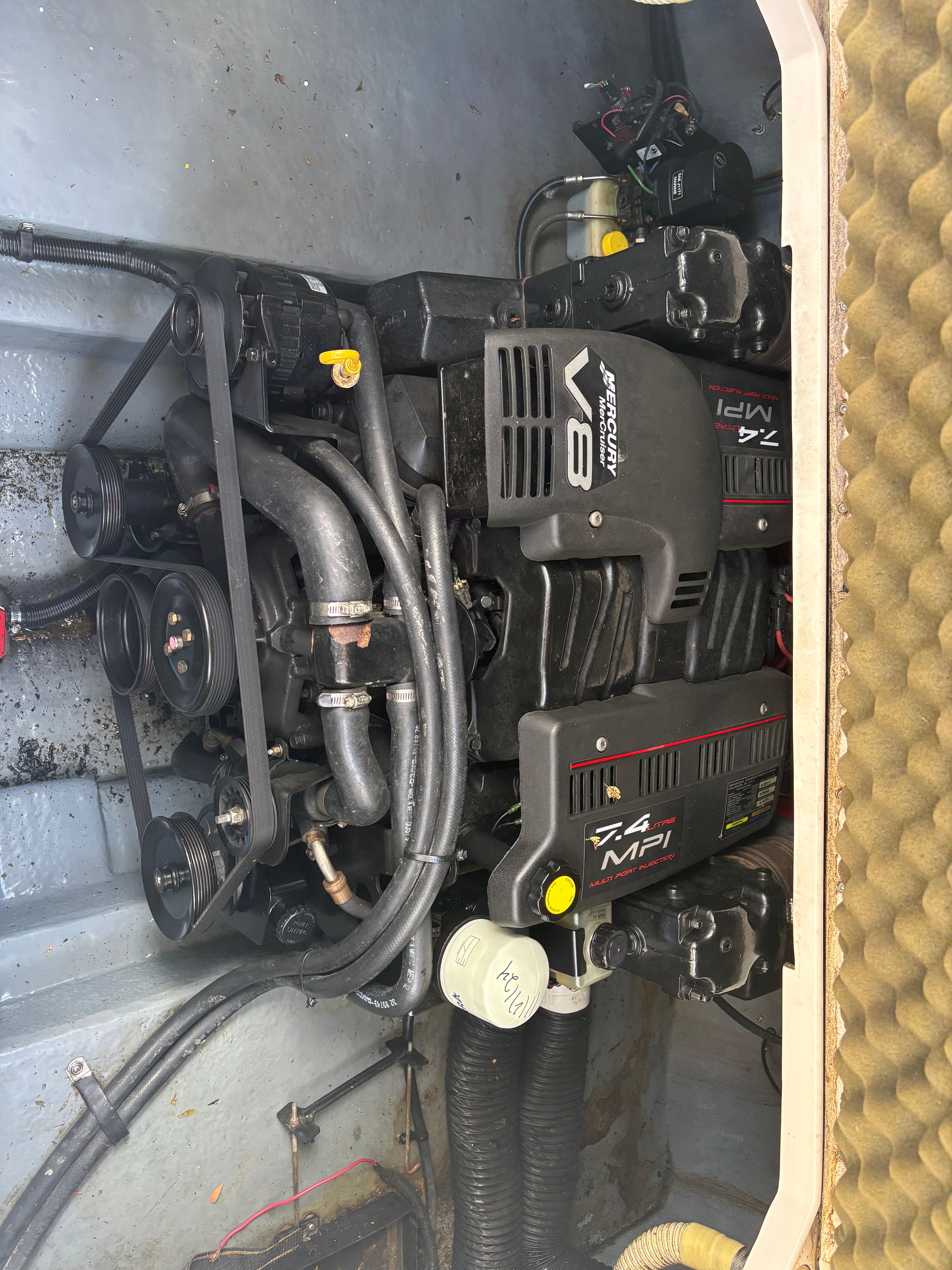 An engine compartment with a 7.4 MPI V8 engine, surrounded by hoses and cables.