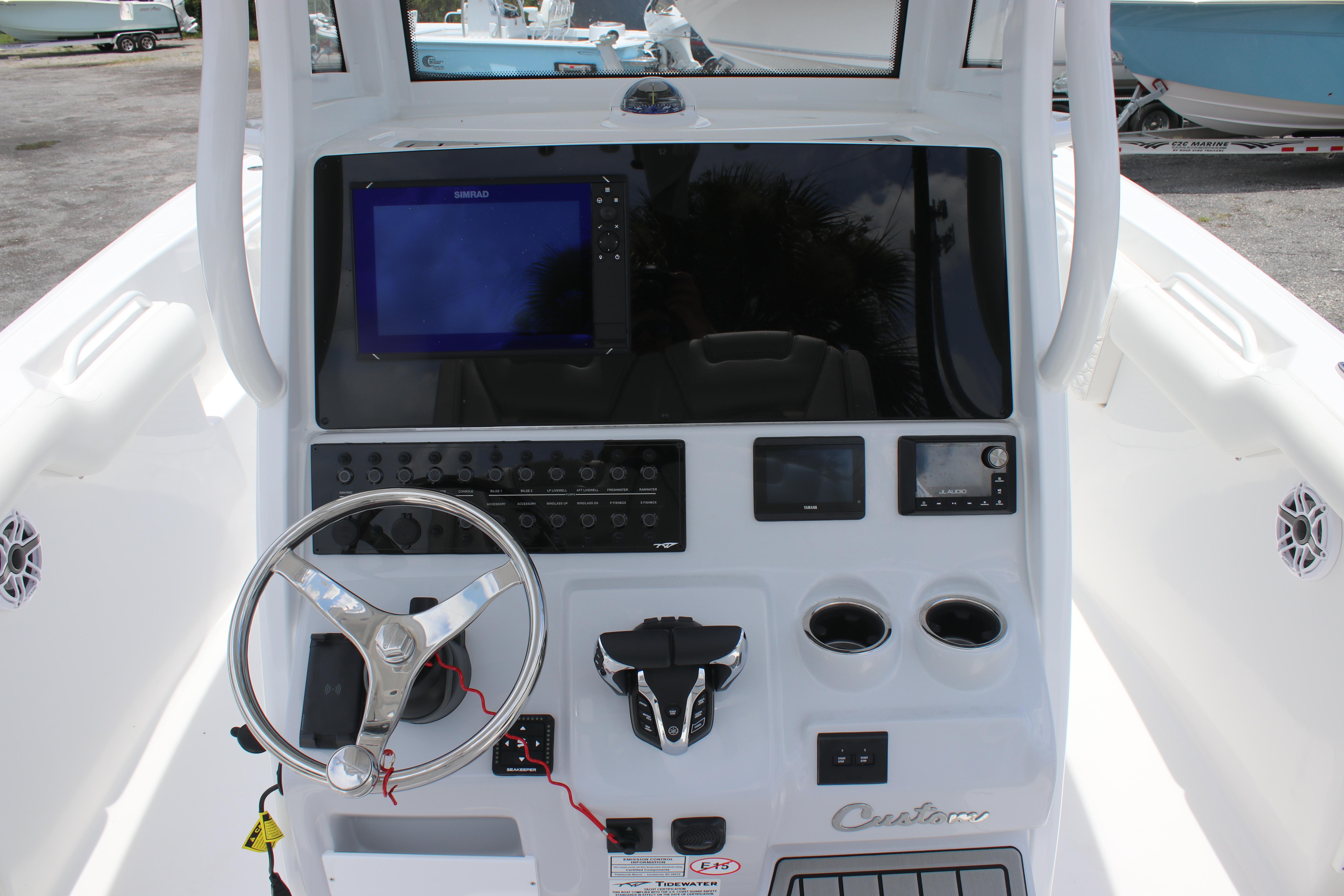 2026 Tidewater 272 LXF boat dashboard with steering wheel and electronic controls.