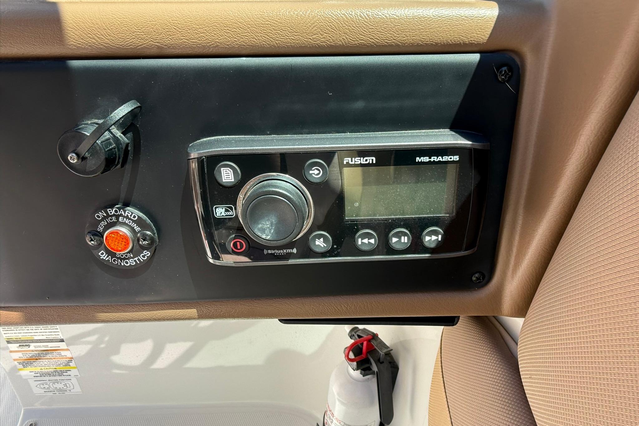 Control panel of a 2016 Crownline 255 SS boat with Fusion MS-RA205 stereo.