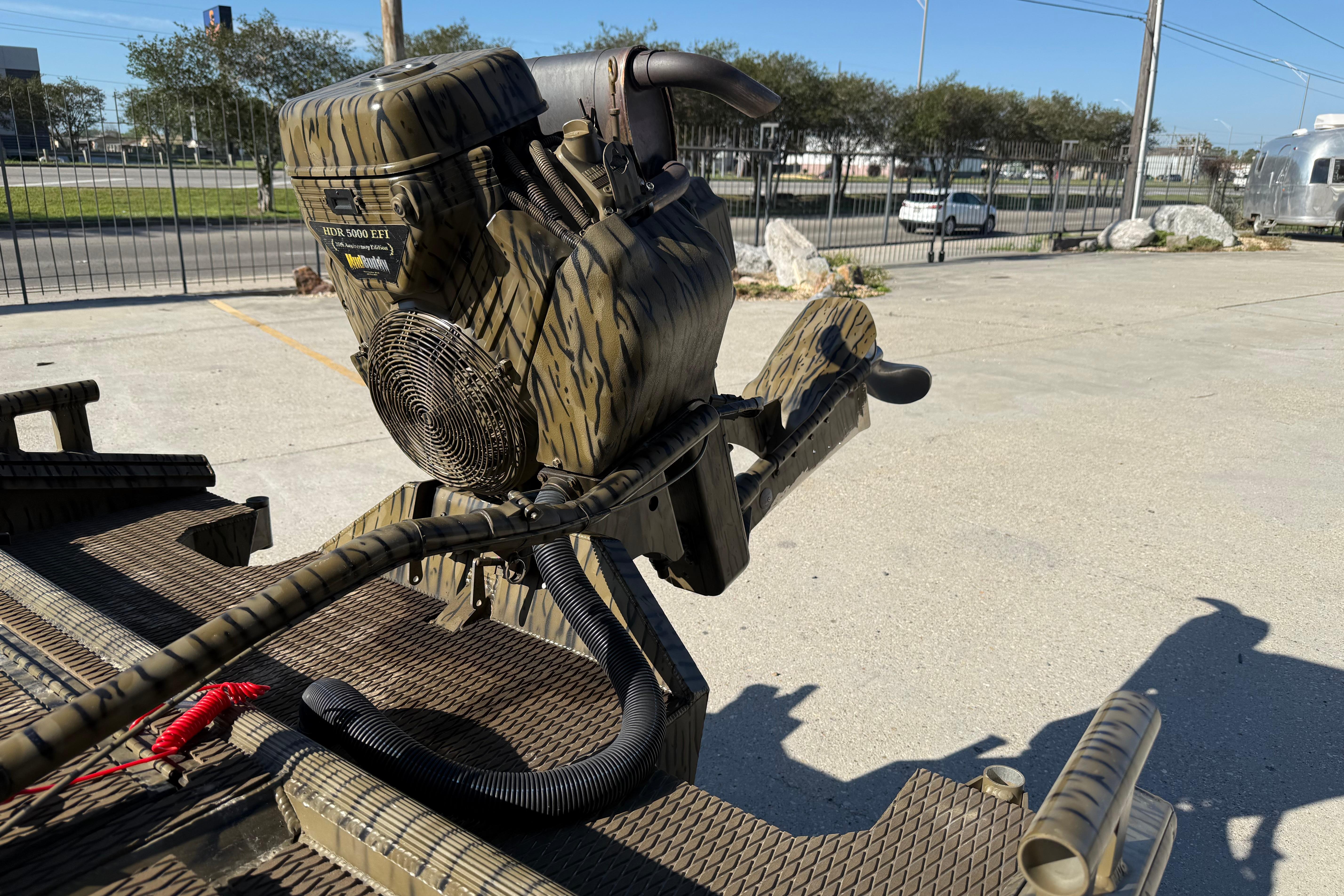 Camouflage-patterned Prodigy 1854 boat motor, 2022 model, in an outdoor setting.