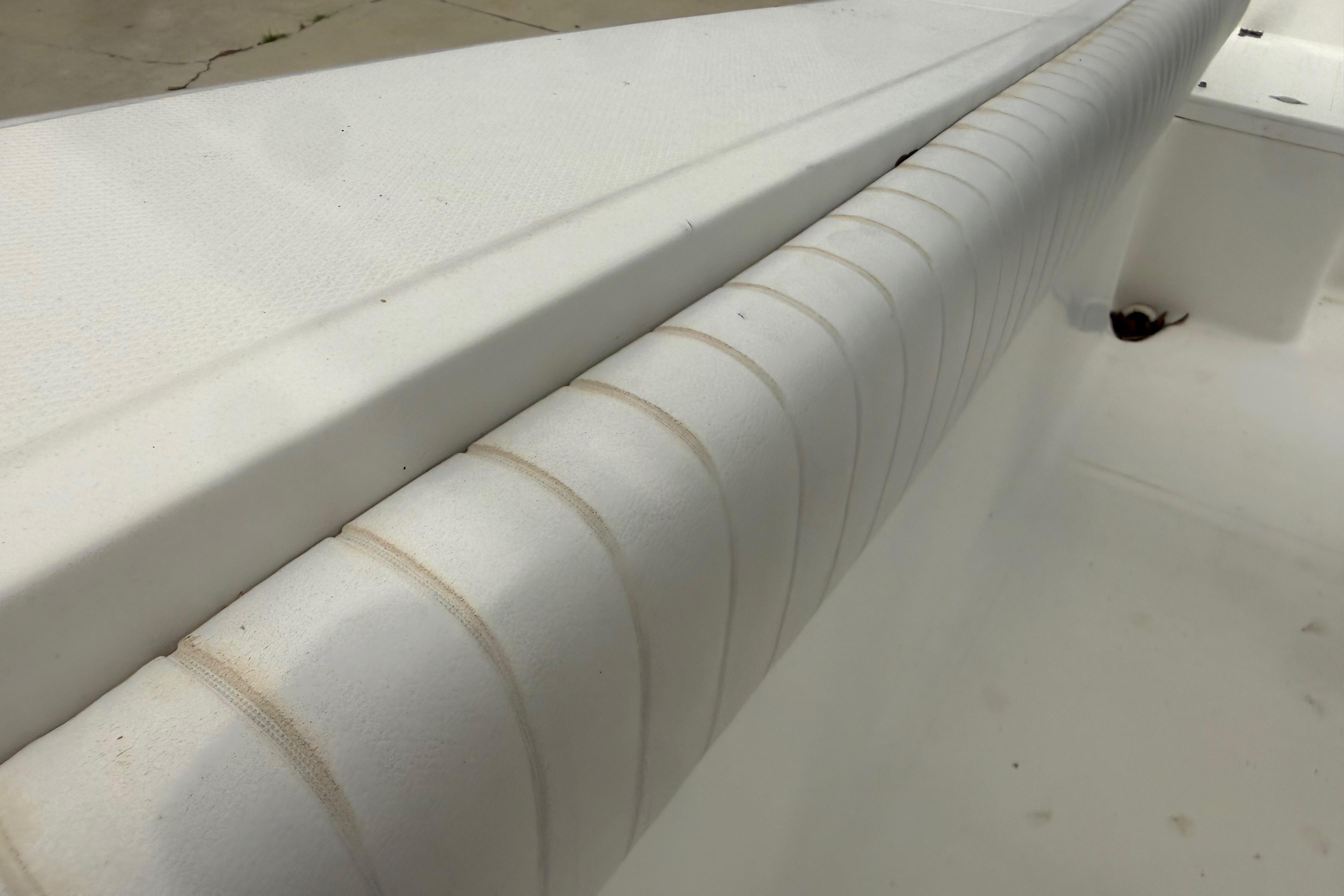 Close-up of 2012 Clearwater 2000 Center Console boat's white interior seating detail.